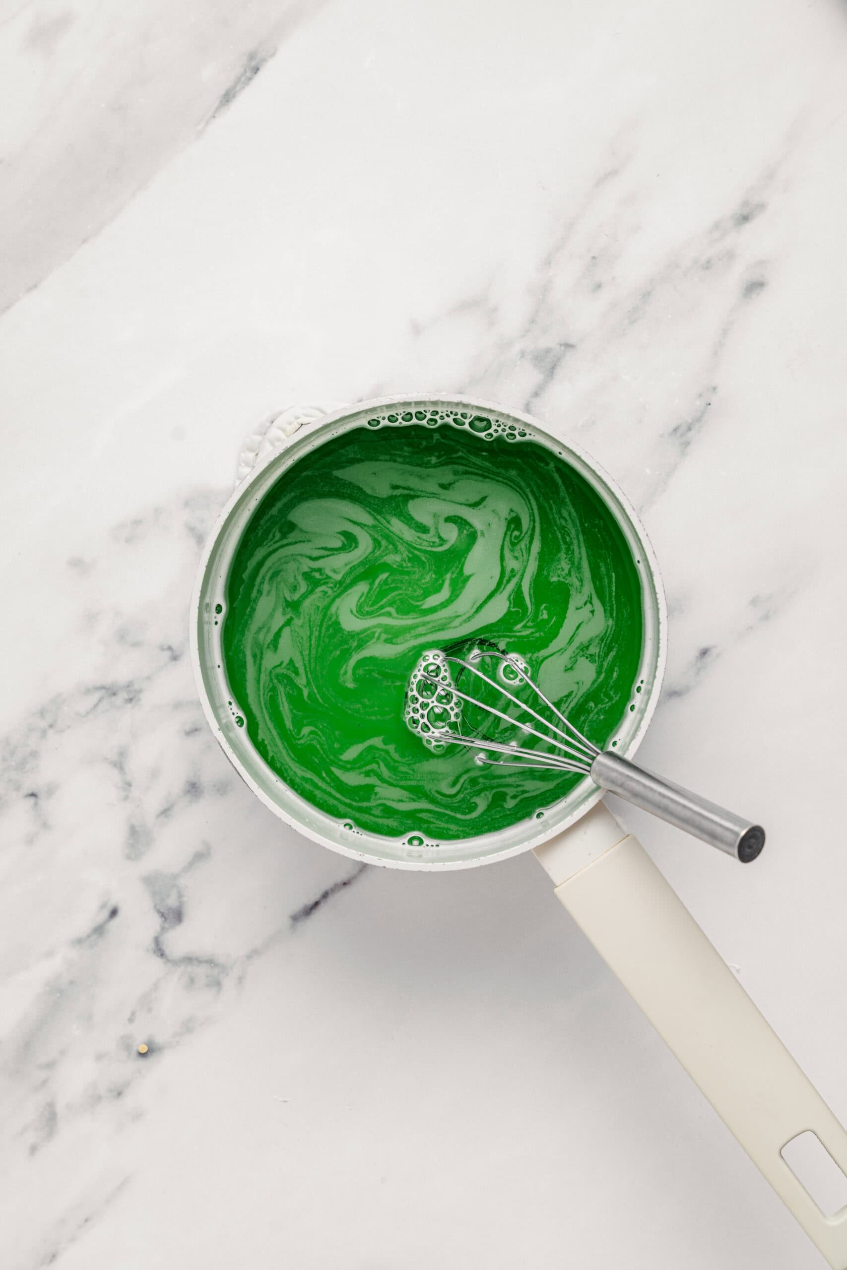 Green pandan extract swirled into the agar mixture for che ba mau jelly - Catherine Zhang Bright green pandan extract swirled into the agar mixture