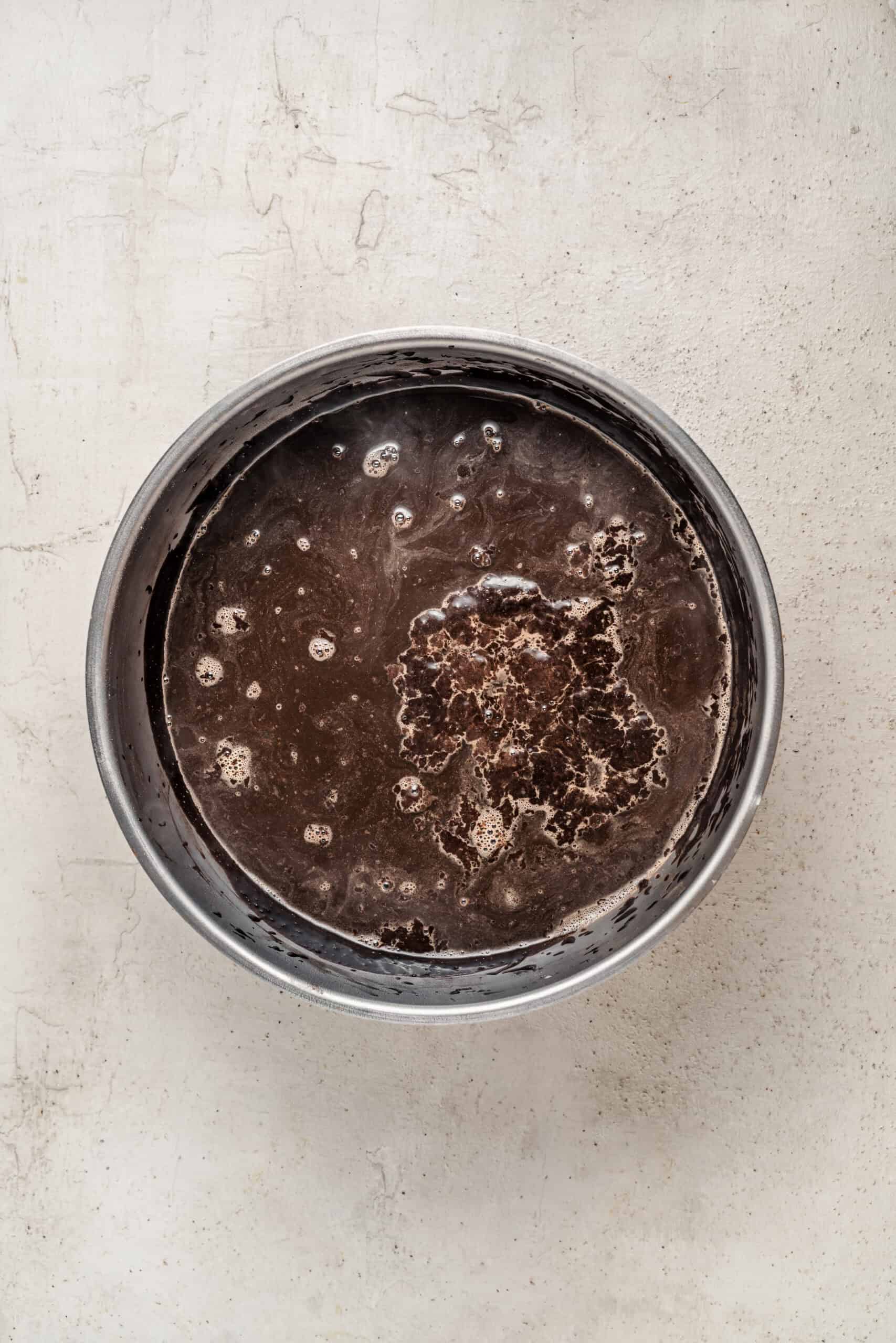 Chocolate cake batter poured into a round pan - Catherine Zhang Chocolate cake batter poured into a round pan