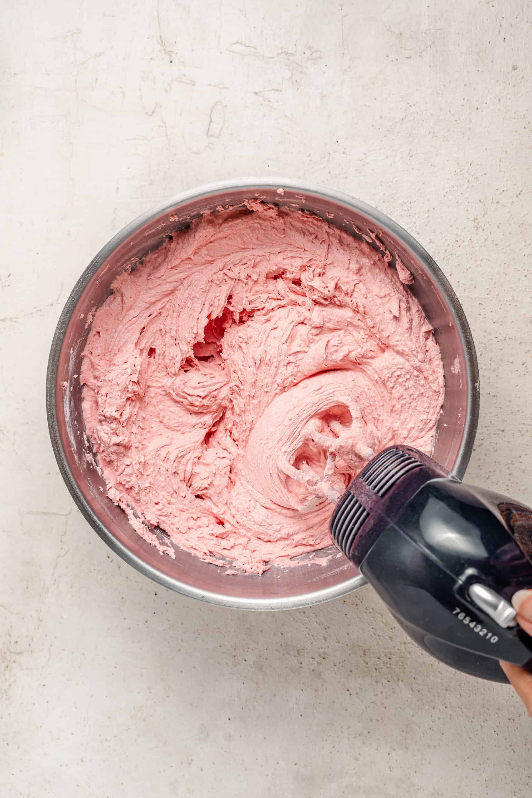 Smooth pink strawberry buttercream in a mixing bowl - Catherine Zhang Smooth pink strawberry buttercream in a mixing bowl
