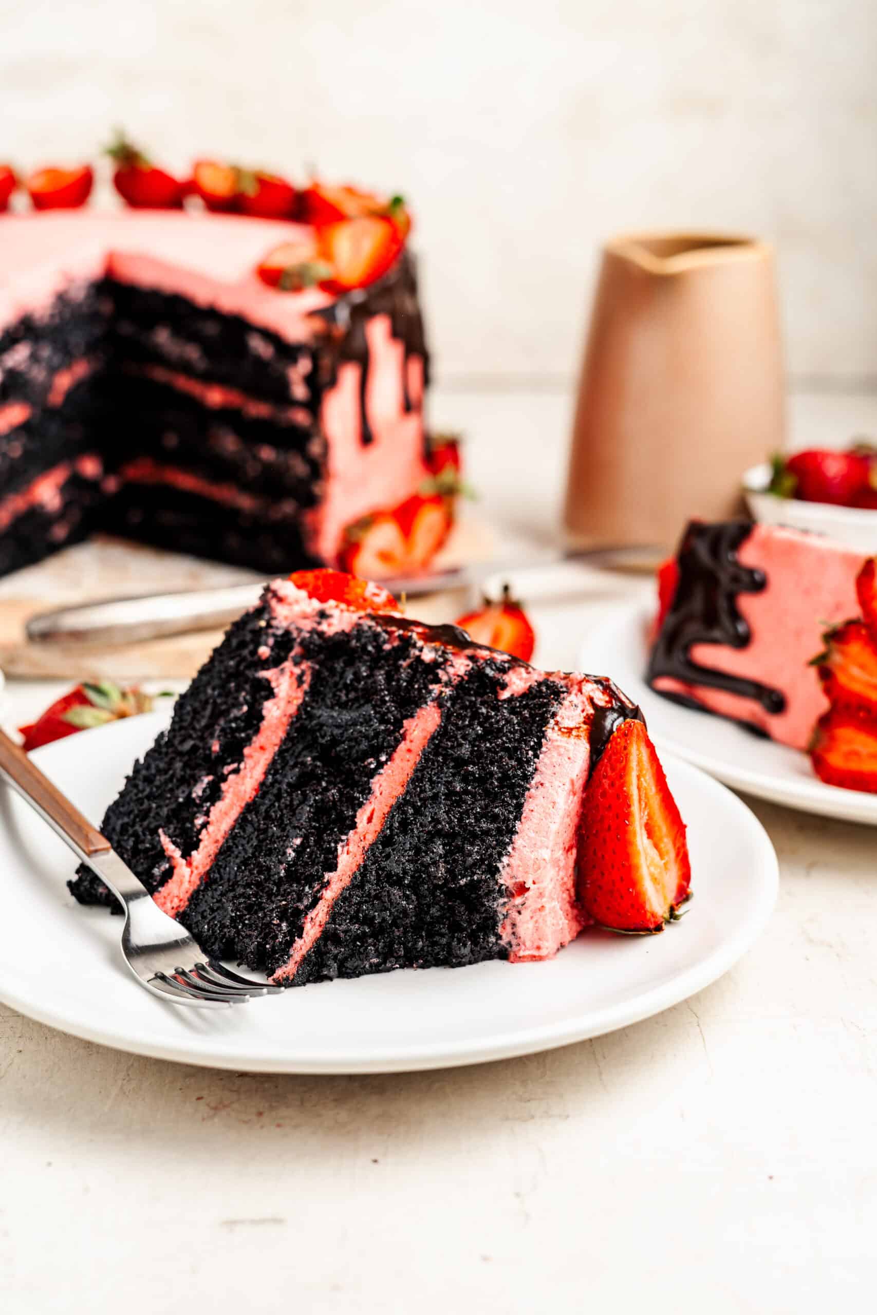 Cross section of chocolate strawberry cake showing three layers - Catherine Zhang Cross section of chocolate strawberry cake showing three layers and pink buttercream