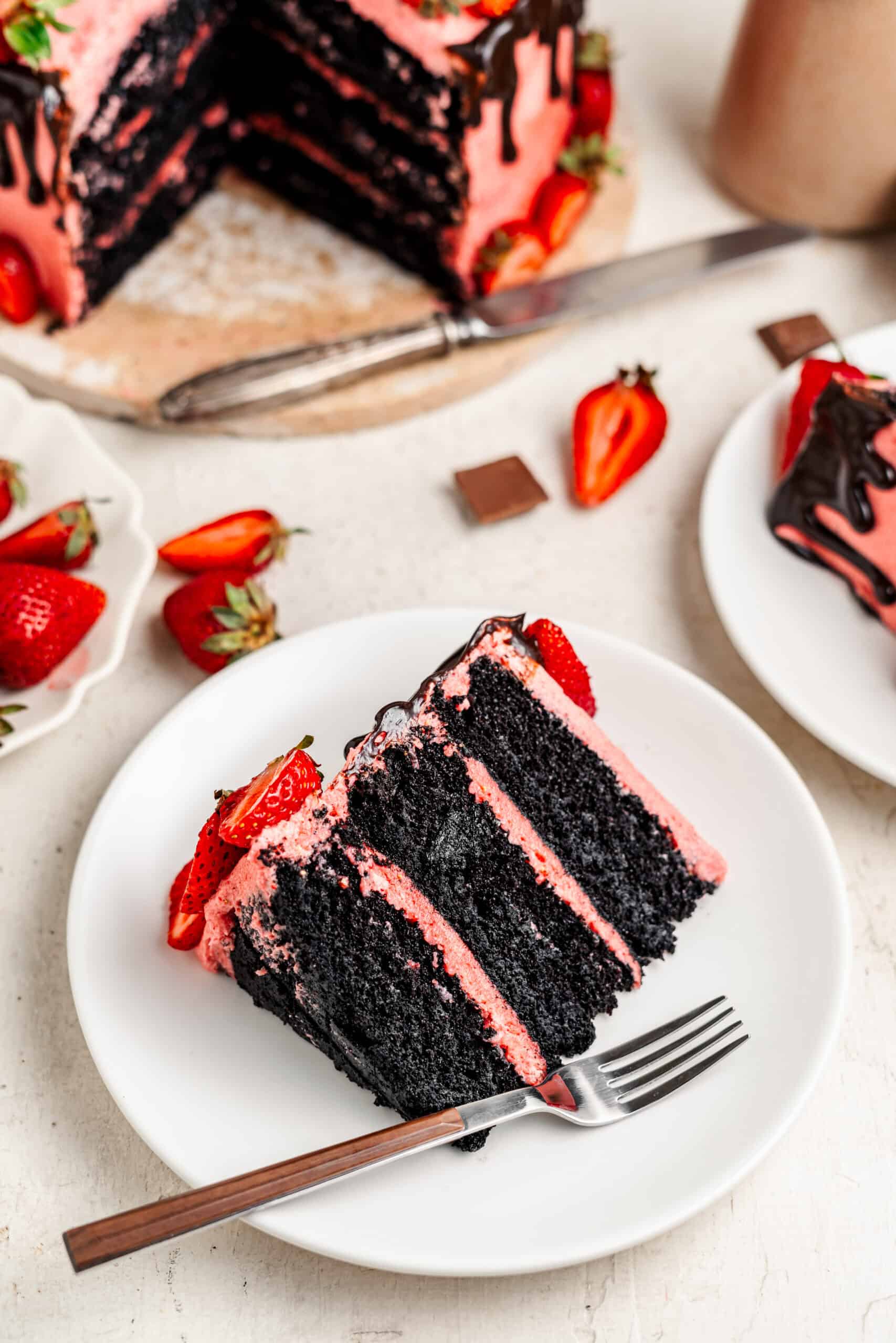 Plated slice of chocolate strawberry cake showing pink buttercream layers - Catherine Zhang Plated slice of chocolate strawberry cake showing pink buttercream layers