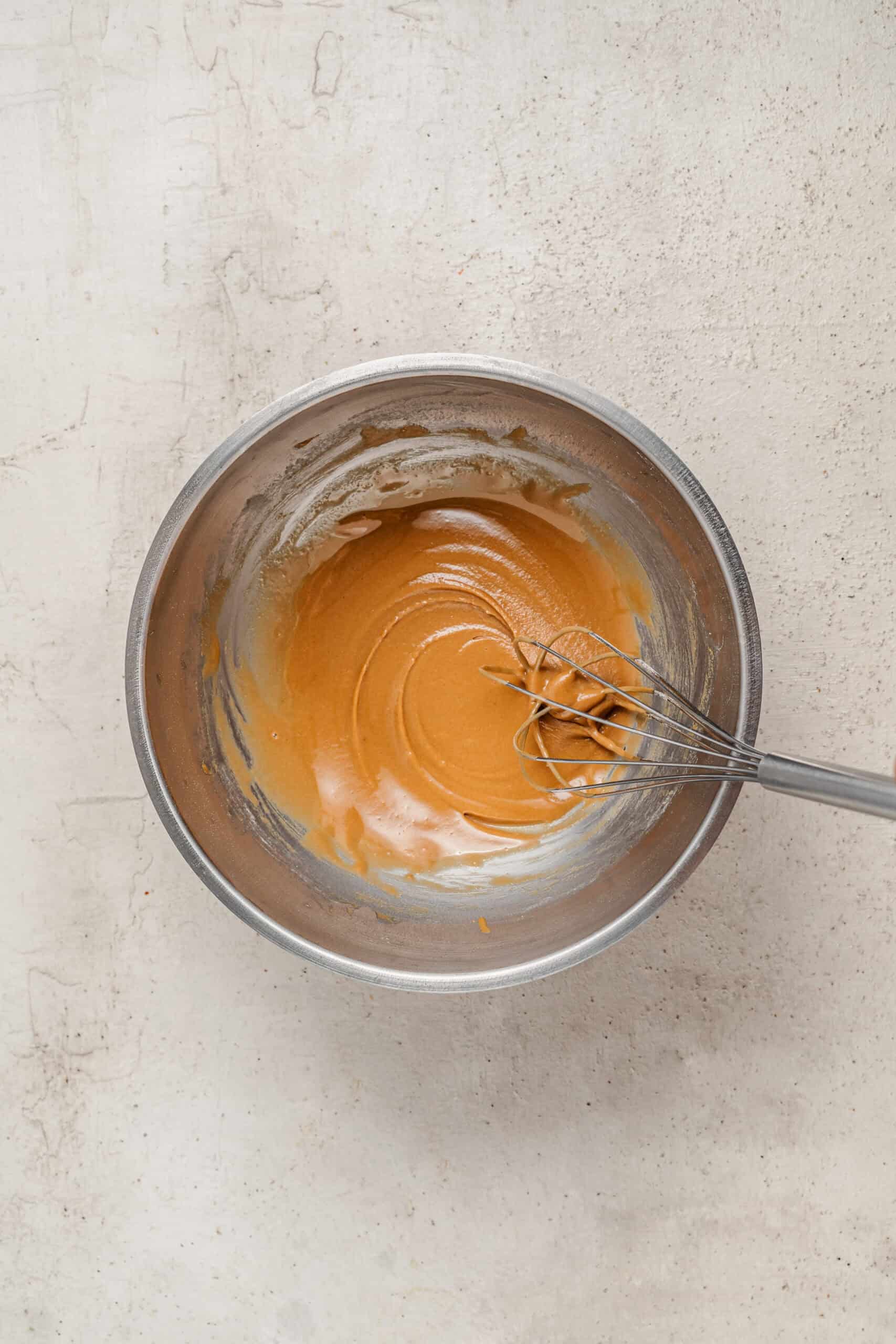 Whisking the coffee glaze until smooth and pourable - Catherine Zhang Whisking the coffee glaze until smooth and pourable
