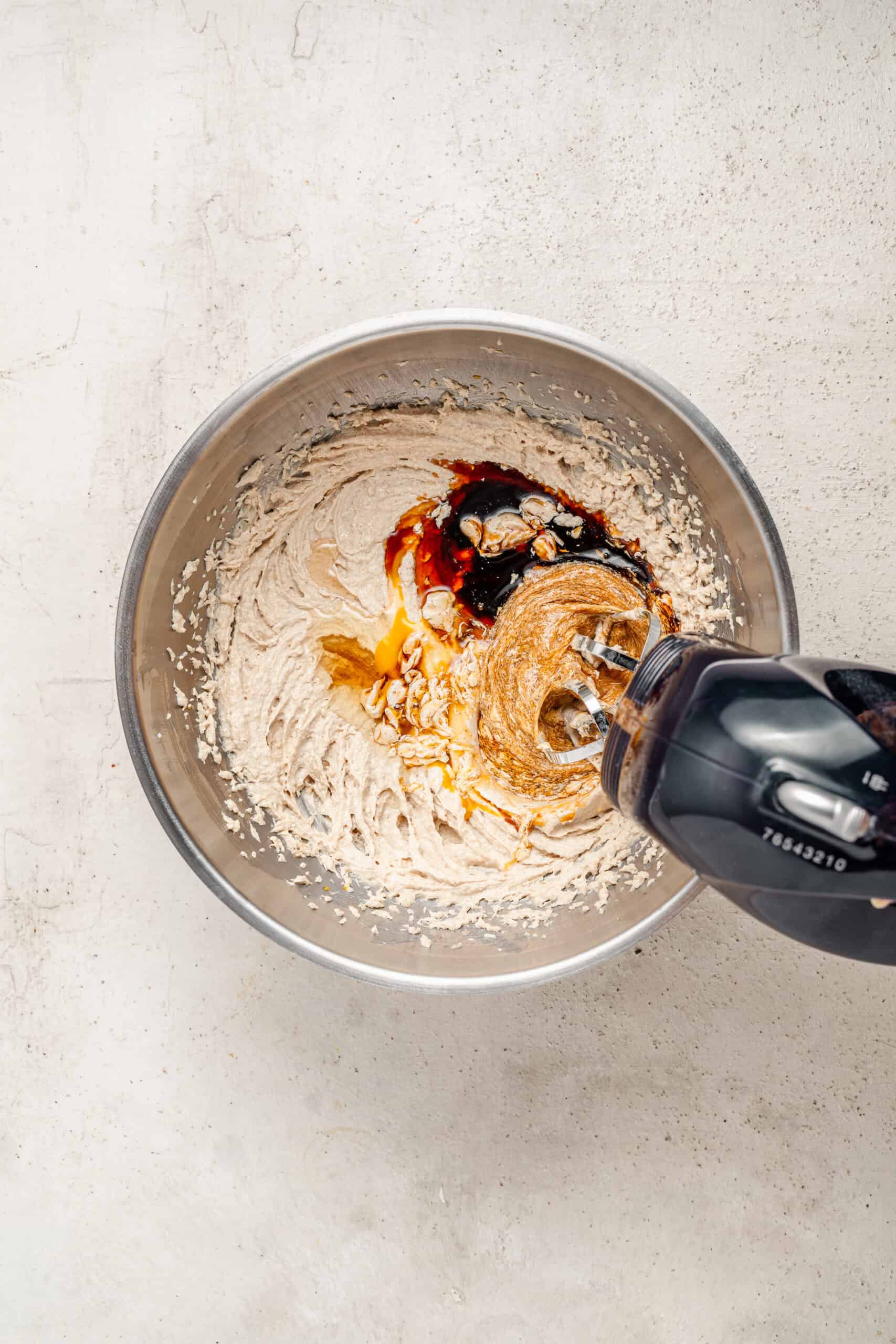 Beating molasses, egg and vanilla into the creamed butter - Catherine Zhang Beating molasses, egg and vanilla into the creamed butter
