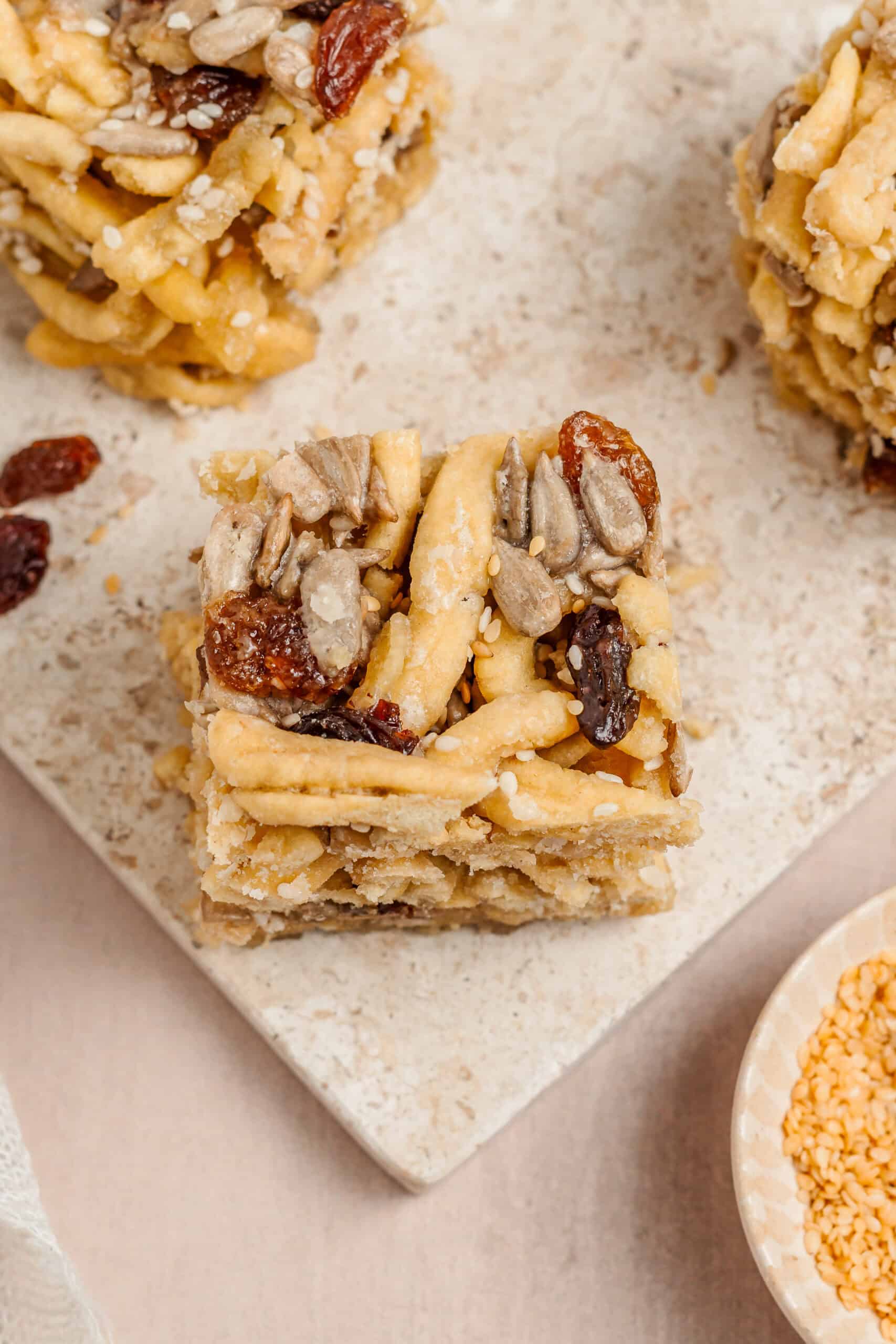Sachima Bars With Raisins - Catherine Zhang Close up of sachima bars showing raisins and toasted seeds
