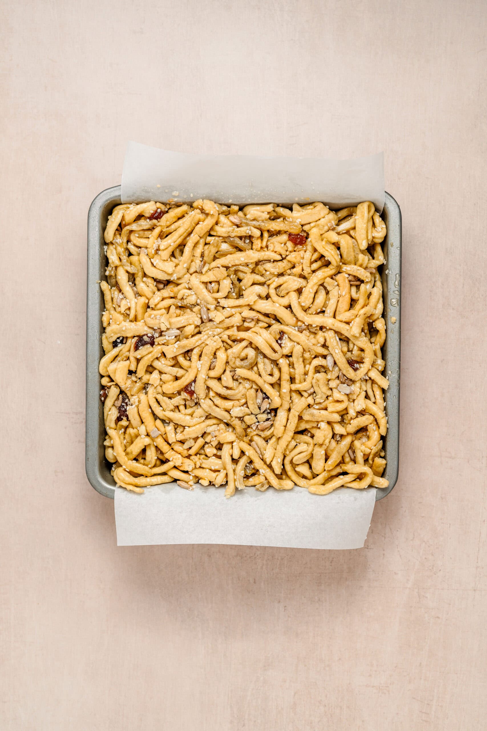 Sachima Pressed Into Pan - Catherine Zhang Syrup coated sachima noodles pressed into a parchment lined pan