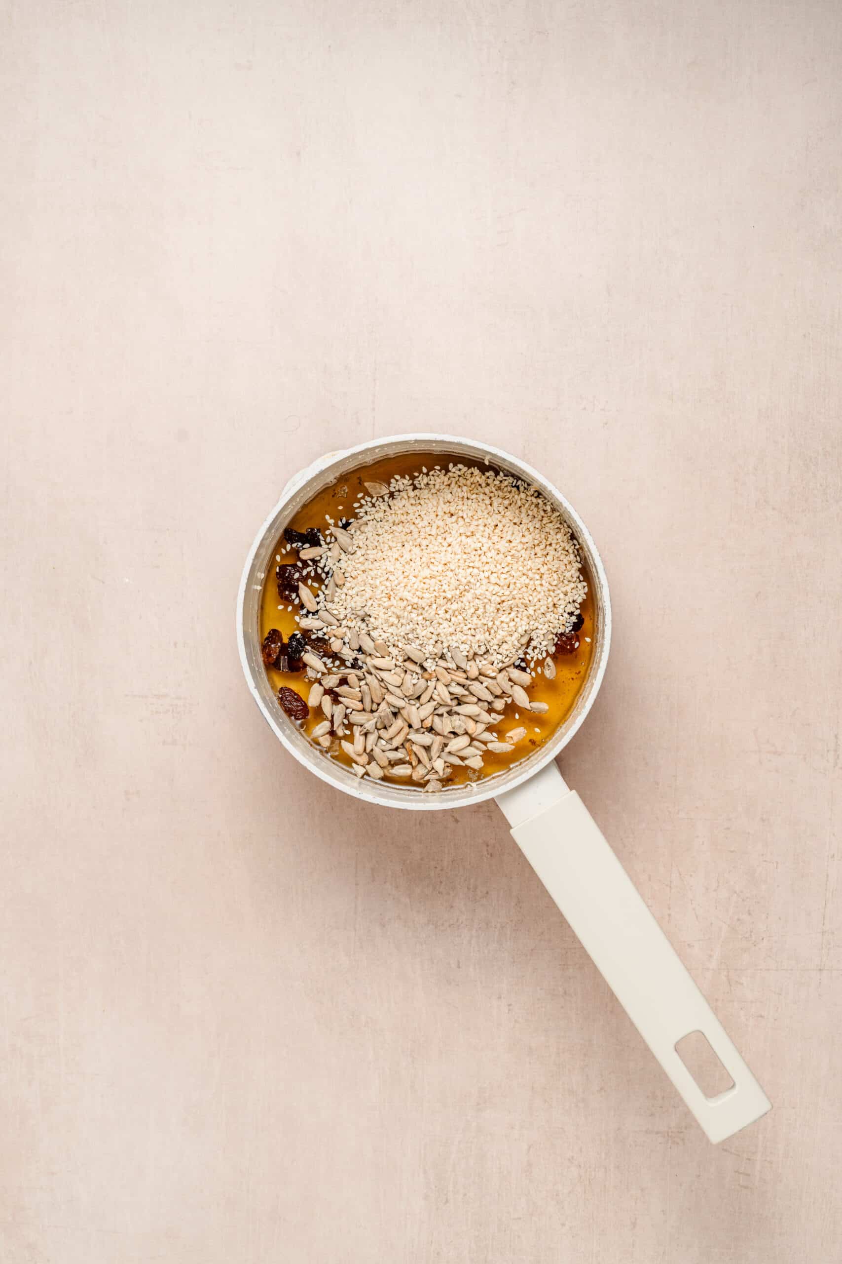 Sachima Syrup With Mix Ins - Catherine Zhang Raisins and sesame seeds stirred into hot sachima syrup