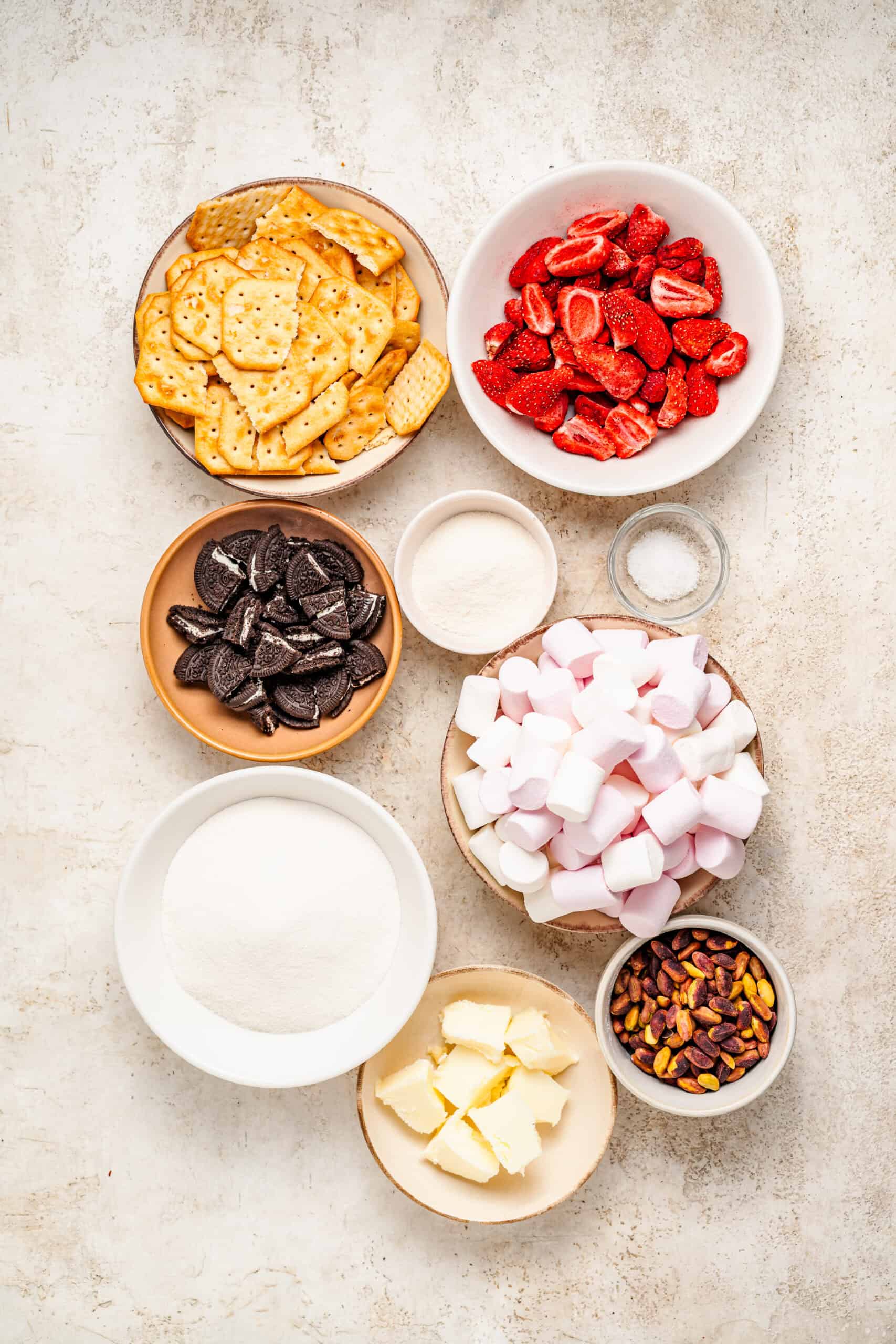 Snowflake crisp ingredients flat lay with crackers, Oreos, freeze dried strawberries and pistachios - Catherine Zhang Snowflake crisp ingredients flat lay with crackers, Oreos, freeze dried strawberries and pistachios