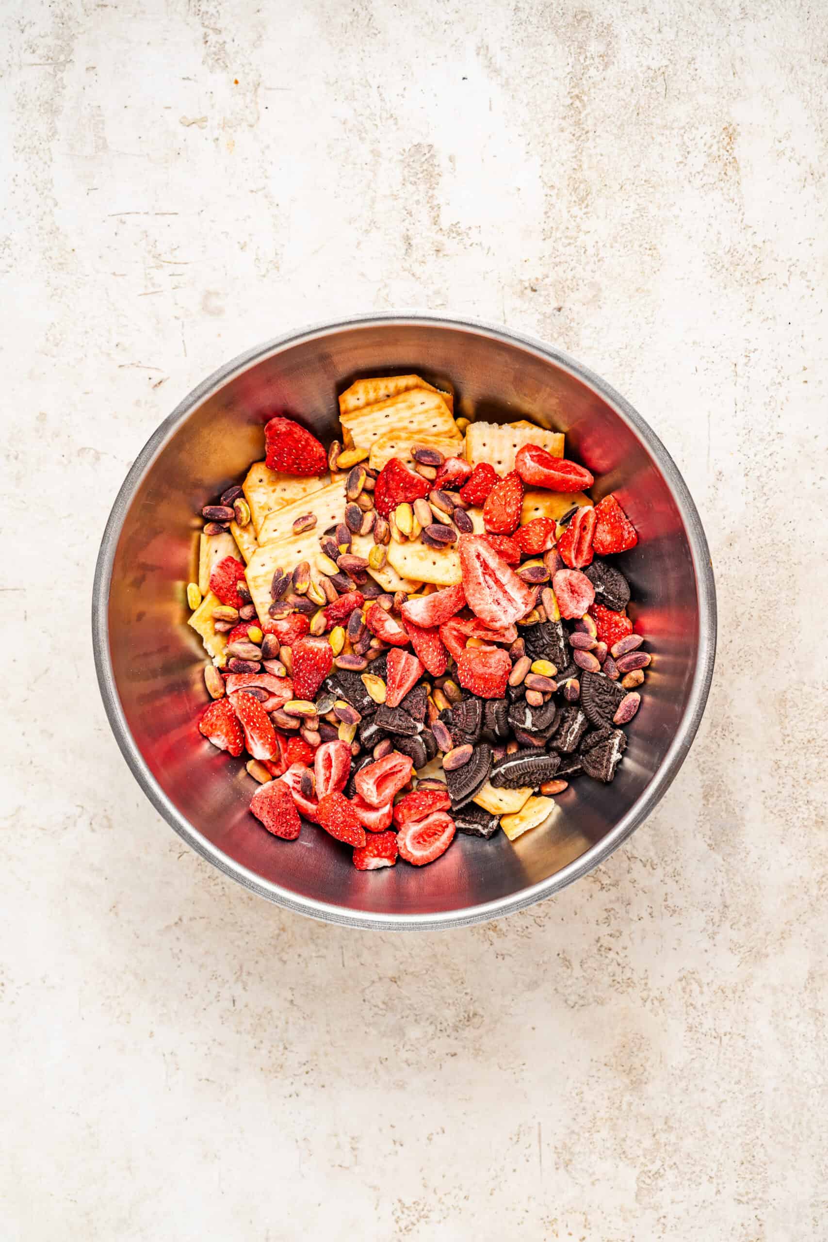 Snowflake crisp mix-ins of crackers, Oreos, strawberries and pistachios in a bowl - Catherine Zhang Snowflake crisp mix-ins of crackers, Oreos, strawberries and pistachios in a bowl