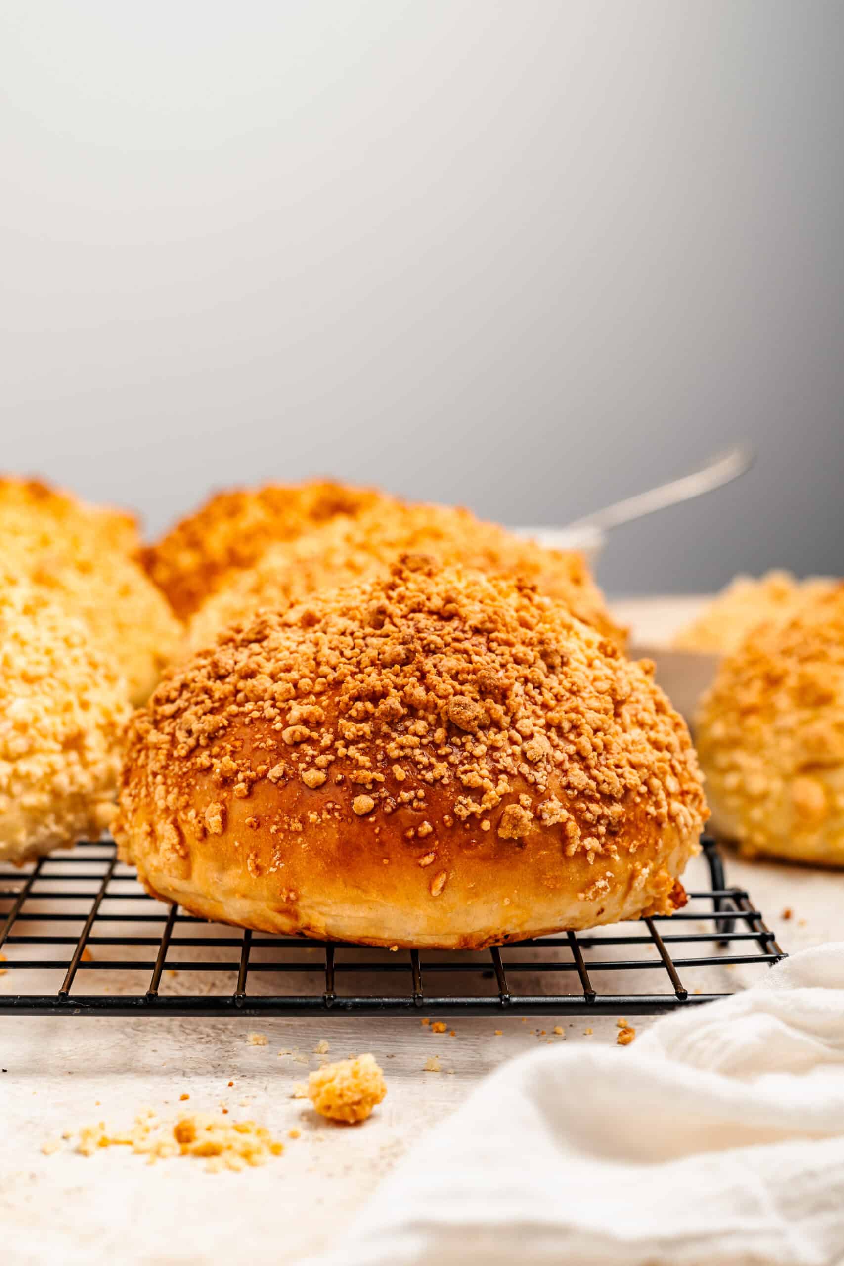 Single soboro bread bun showing the crackled streusel top - Catherine Zhang Single soboro bread bun showing the crackled streusel top
