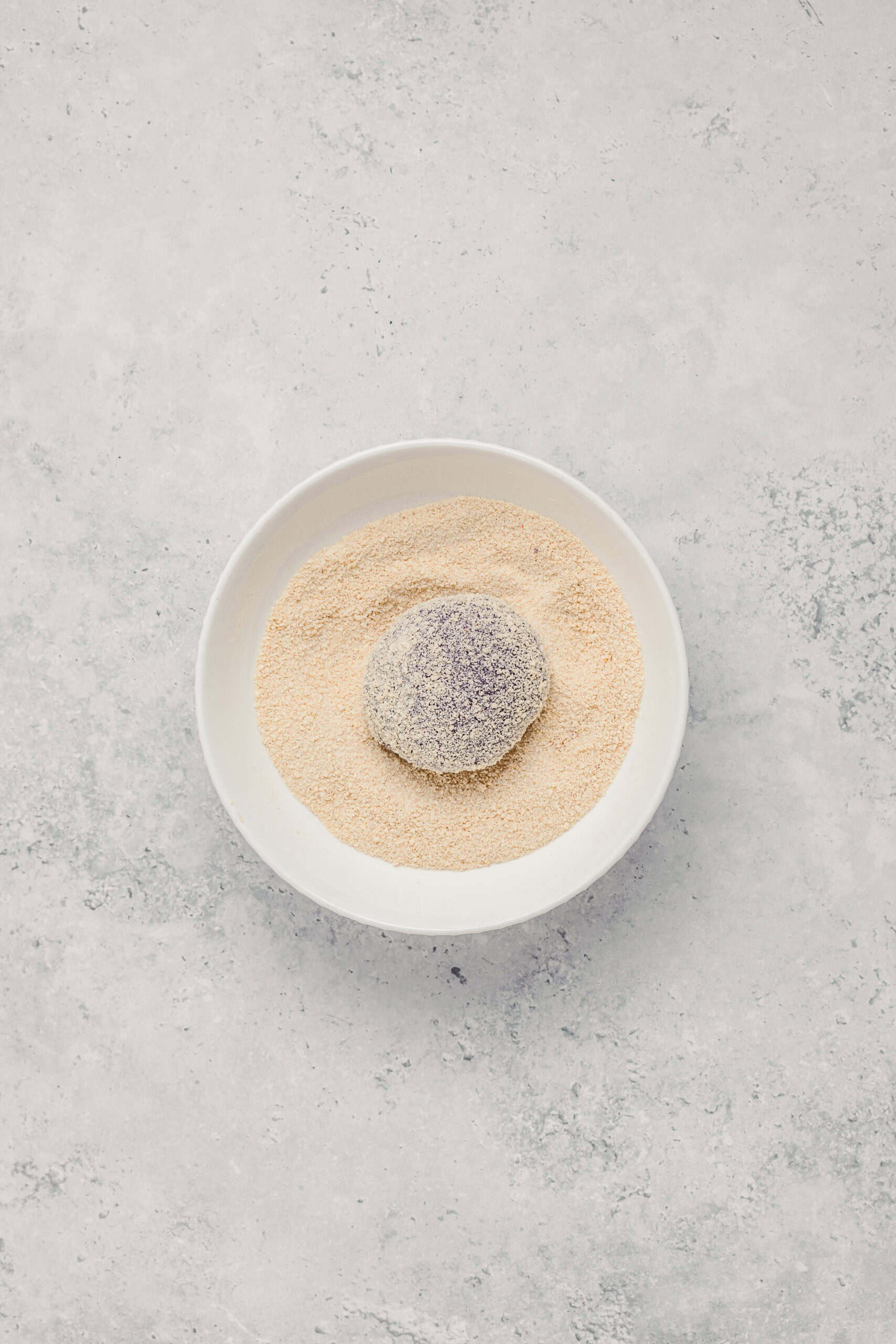 Breadcrumb Coating - Catherine Zhang Stuffed ube pandesal ball rolled in fine breadcrumbs for the signature coating