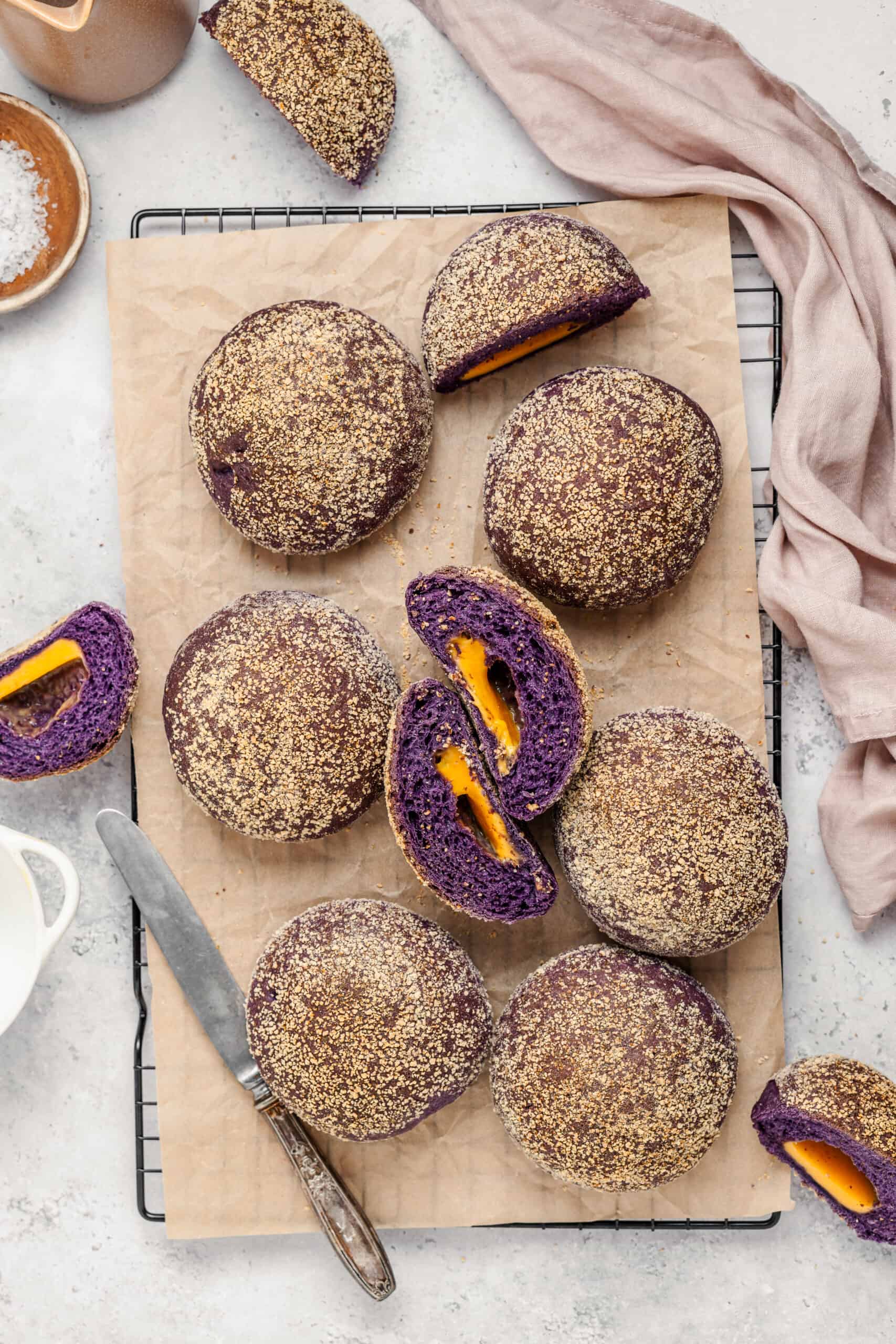 Ube Cheese Pandesal - Catherine Zhang Ube cheese pandesal rolls on a board with one split open beside a mug of Filipino coffee