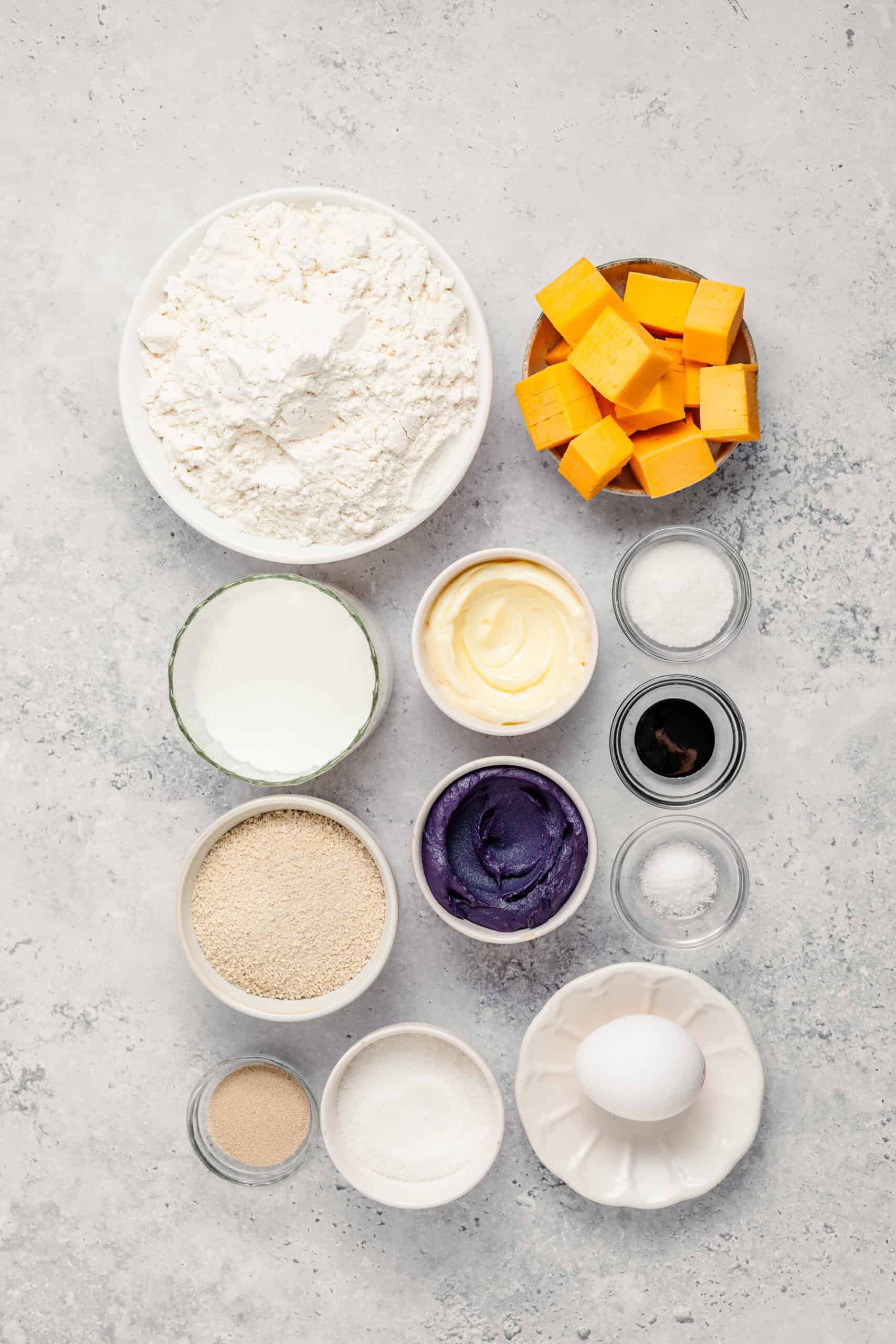 Ube Cheese Pandesal Ingredients - Catherine Zhang Ube cheese pandesal ingredients flat lay with bread flour, ube halaya, cheddar cubes, milk and butter