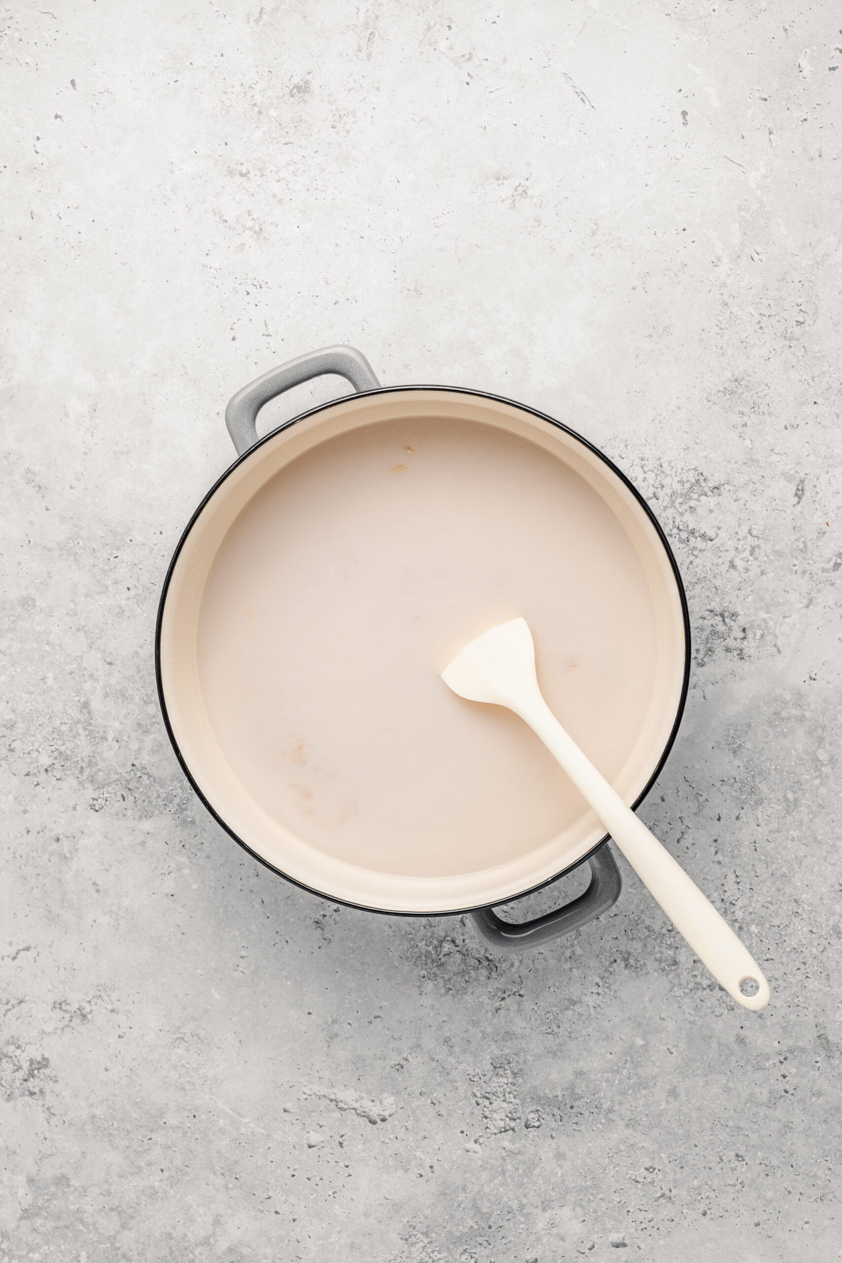 Glutinous rice, water and coconut milk in a heavy pot before cooking for biko - Catherine Zhang Glutinous rice, water and coconut milk in a heavy pot before cooking for biko