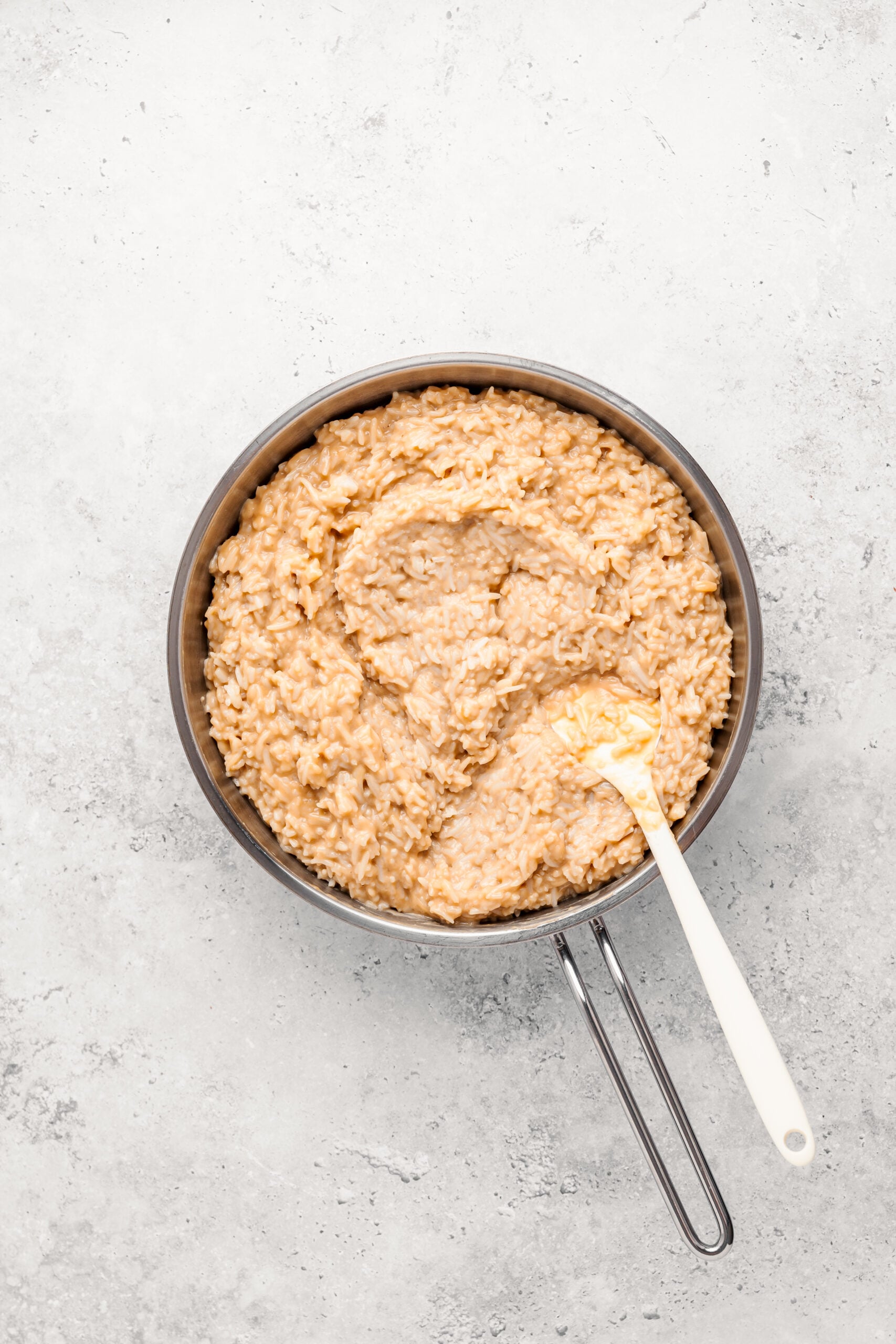 Cooked glutinous rice folded through the coconut caramel into a thick glossy mass for biko - Catherine Zhang Cooked glutinous rice folded through the coconut caramel into a thick glossy mass for biko