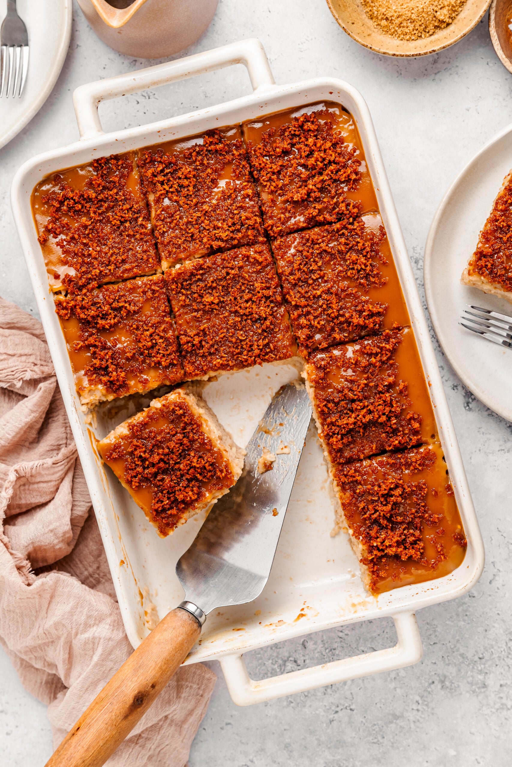 Styled tray of biko sticky rice cake with plates, forks and a linen cloth - Catherine Zhang Styled tray of biko sticky rice cake with plates, forks and a linen cloth