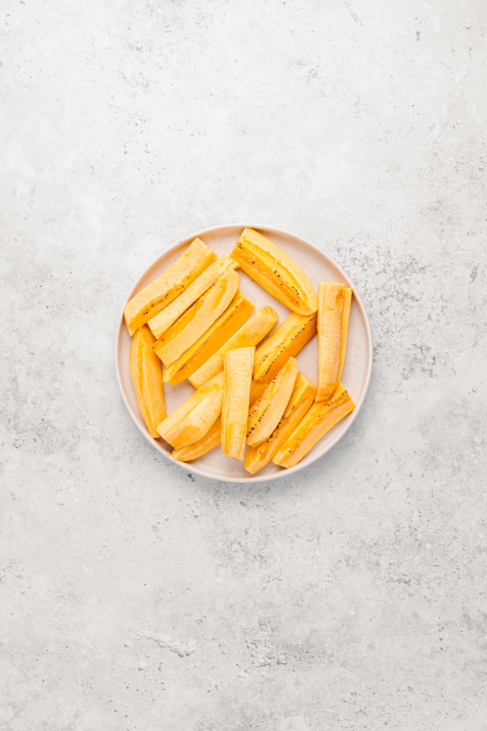 Ripe plantains peeled and cut into flat strips for Filipino turon - Catherine Zhang Ripe plantains peeled and cut into flat strips for Filipino turon