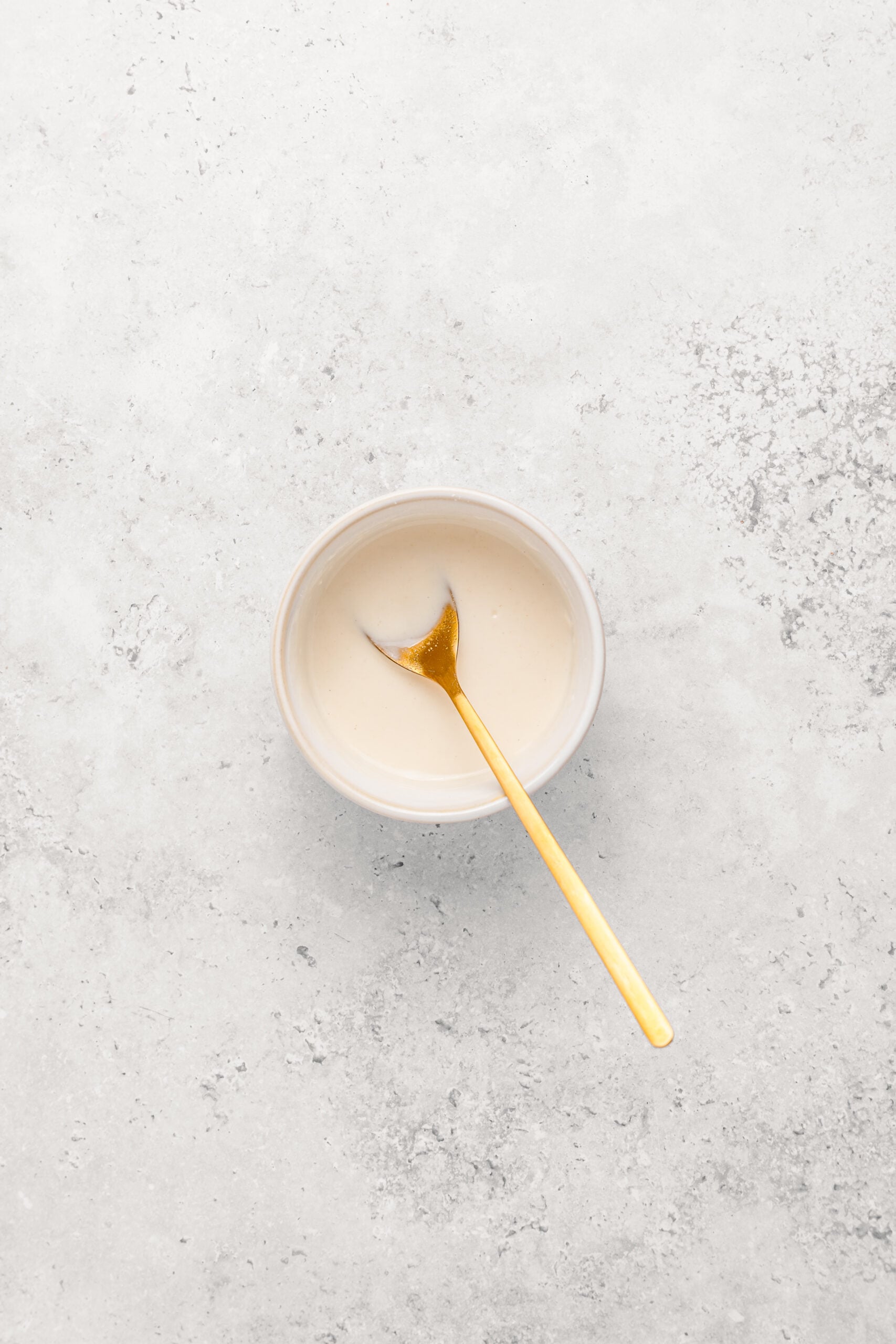 Smooth flour and water paste in a bowl used to seal turon wrappers - Catherine Zhang Smooth flour and water paste in a bowl used to seal turon wrappers