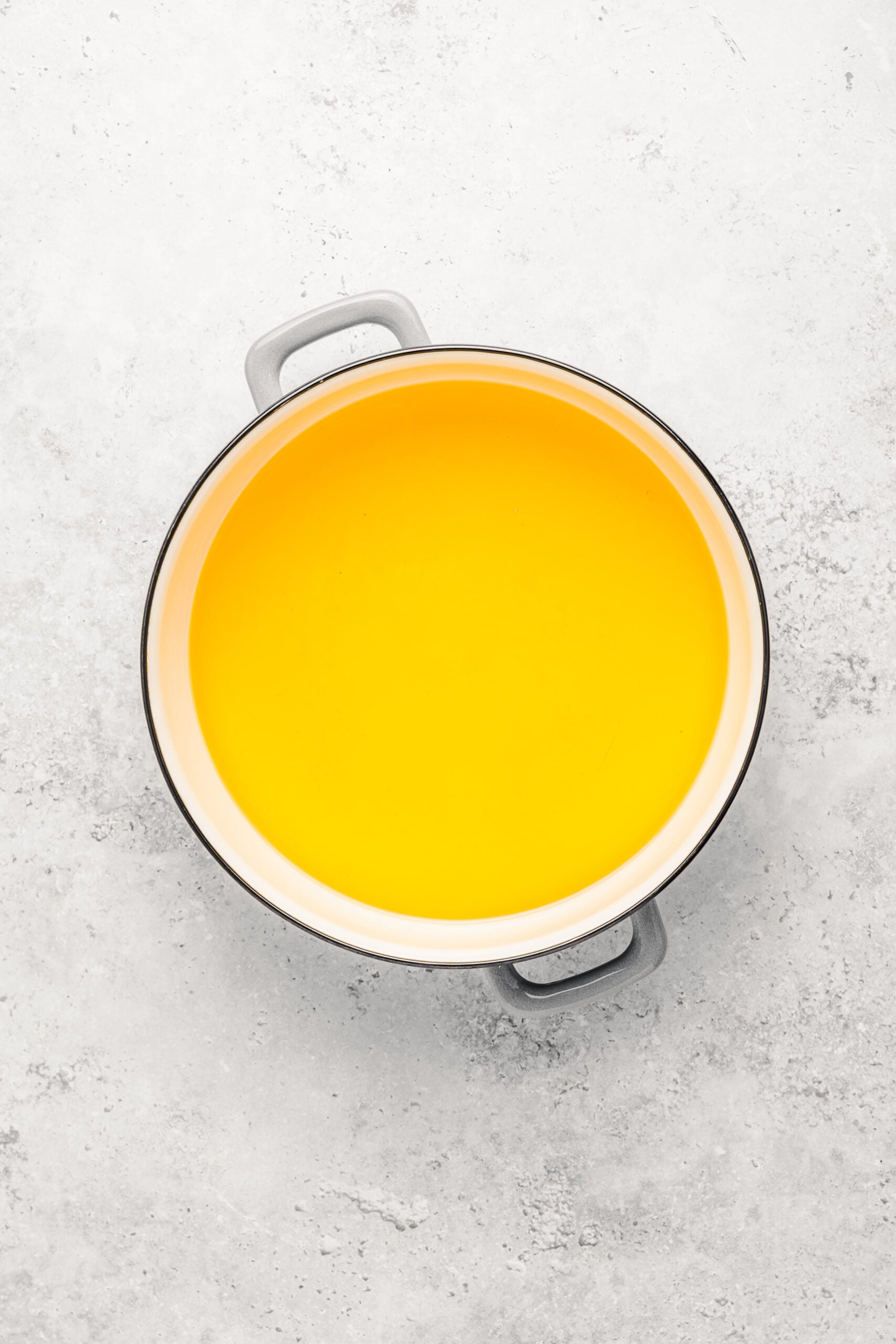Neutral frying oil heating in a deep pot for crispy turon - Catherine Zhang Neutral frying oil heating in a deep pot for crispy turon