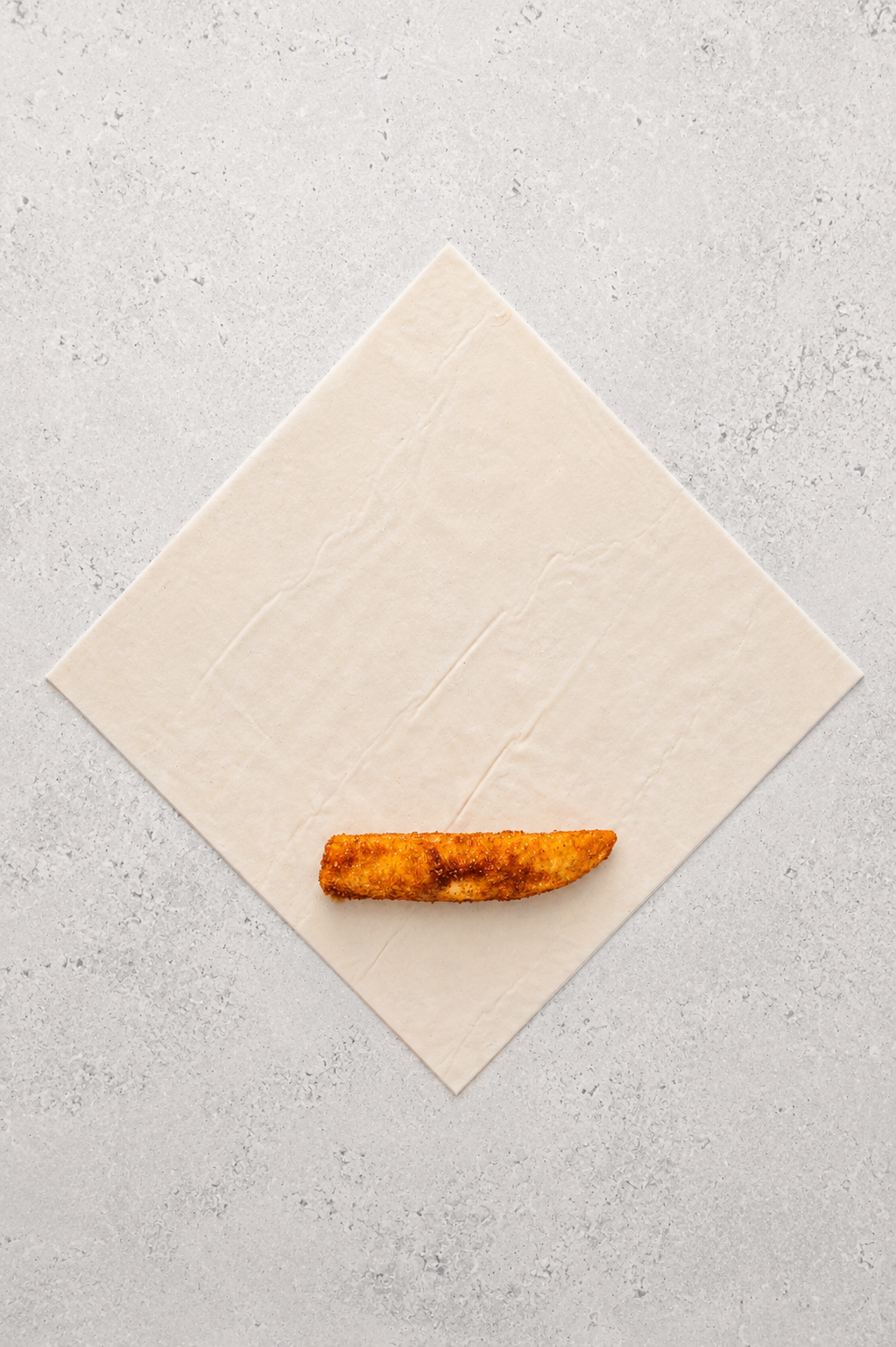 Sugar coated banana laid across a spring roll wrapper set as a diamond for turon - Catherine Zhang Sugar coated banana laid across a spring roll wrapper set as a diamond for turon