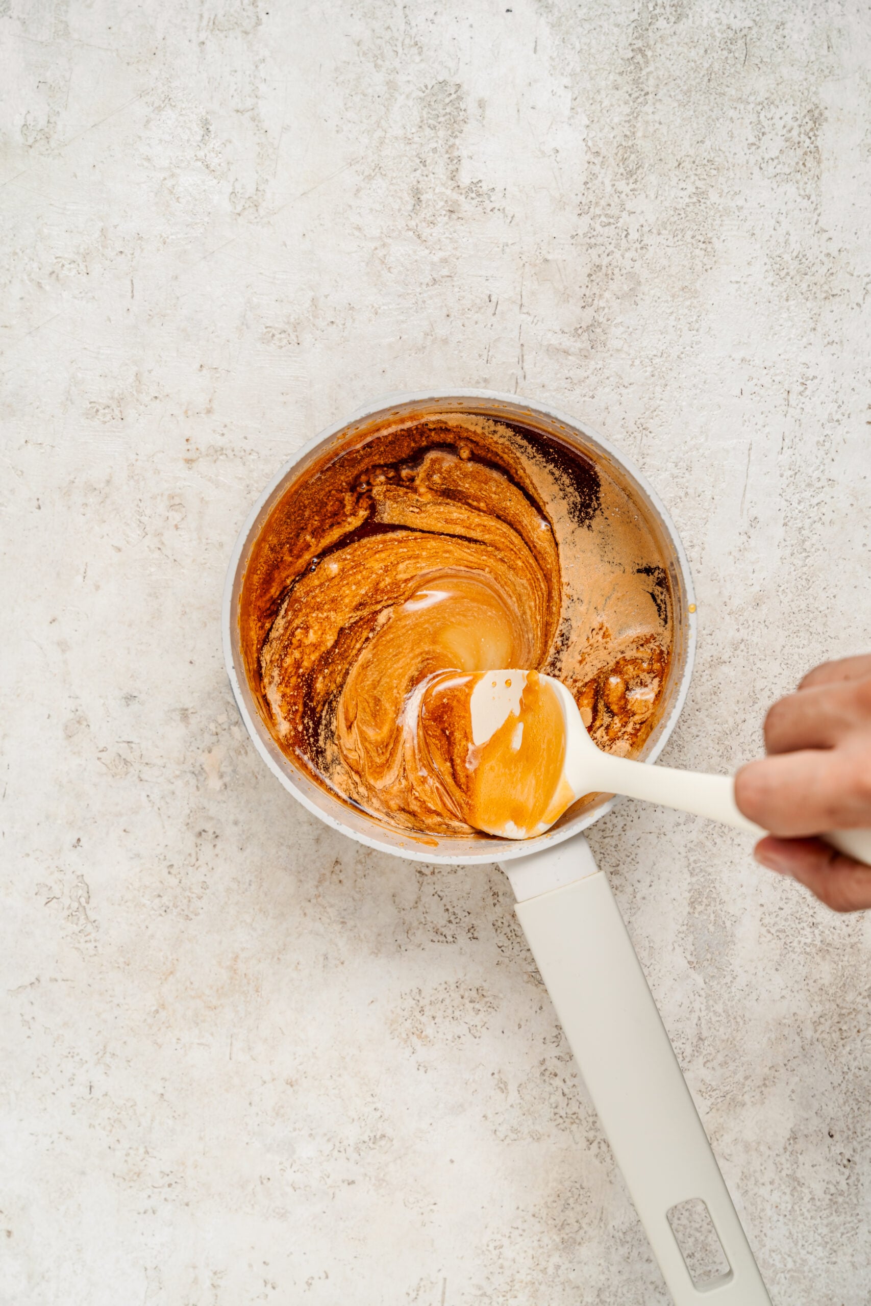 Baking soda stirred into the melted sugar so it foams and puffs - Catherine Zhang Baking soda stirred into the melted sugar so it foams and puffs