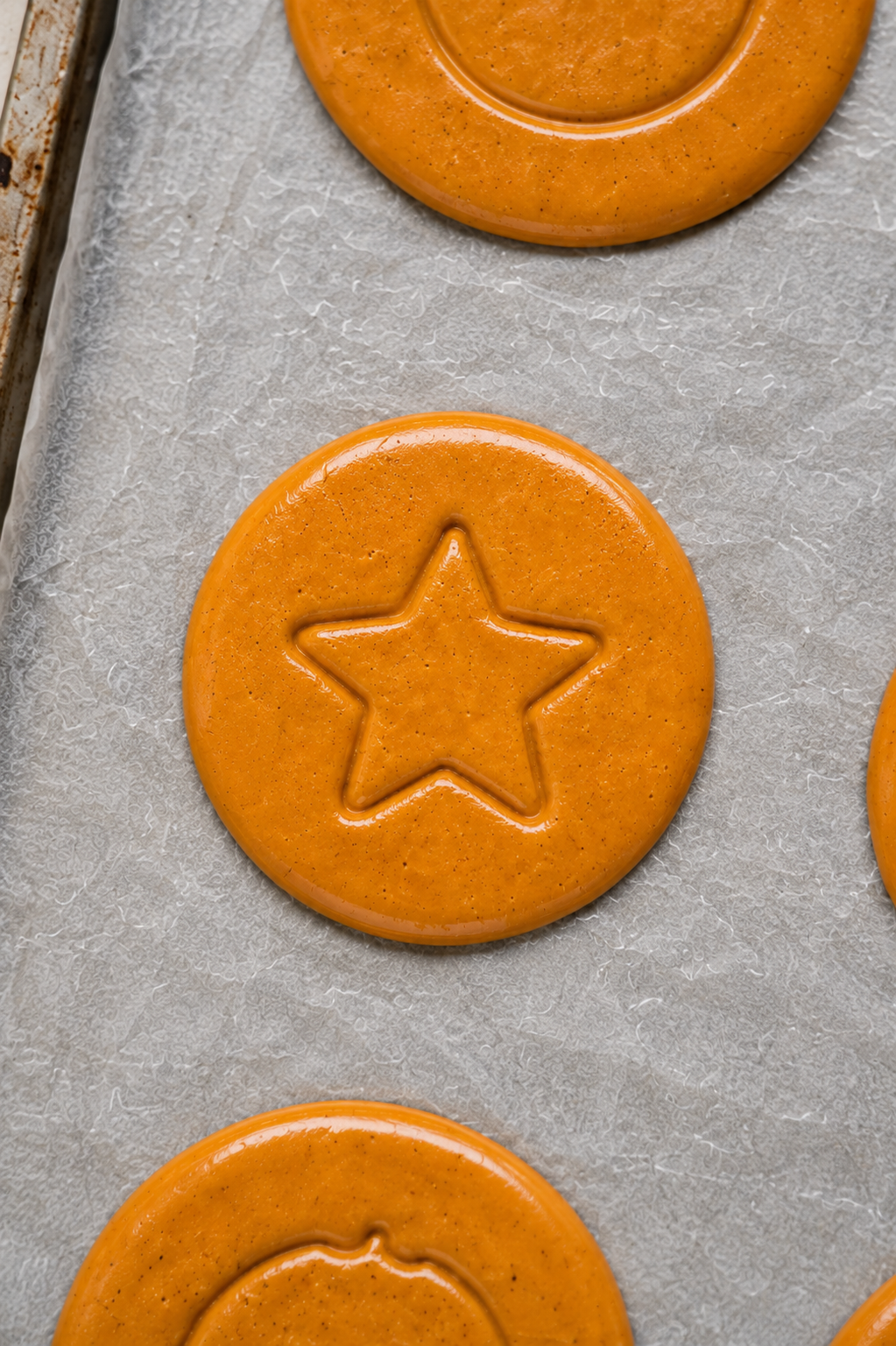 Close up of a dalgona candy disc stamped with a star - Catherine Zhang Close up of a dalgona candy disc stamped with a star