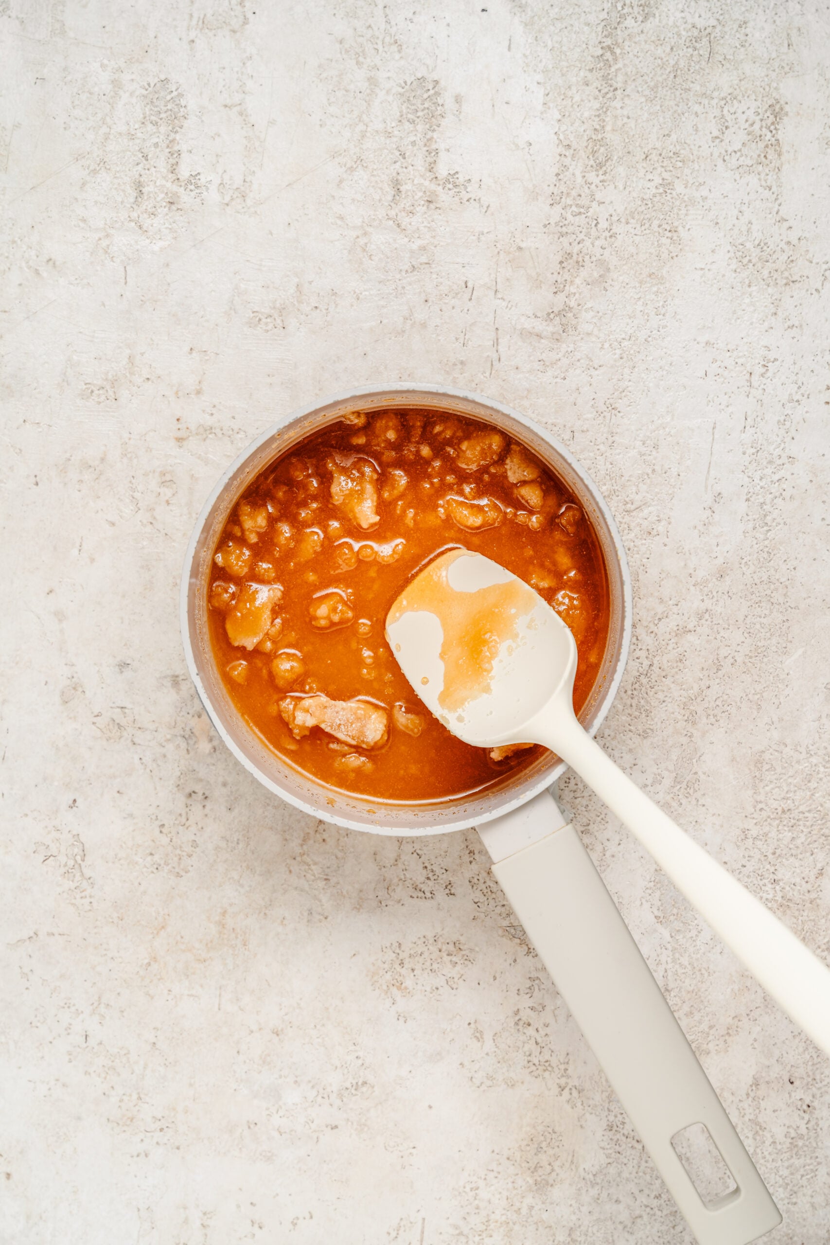 Sugar melting into a bubbling amber liquid - Catherine Zhang Sugar melting into a bubbling amber liquid
