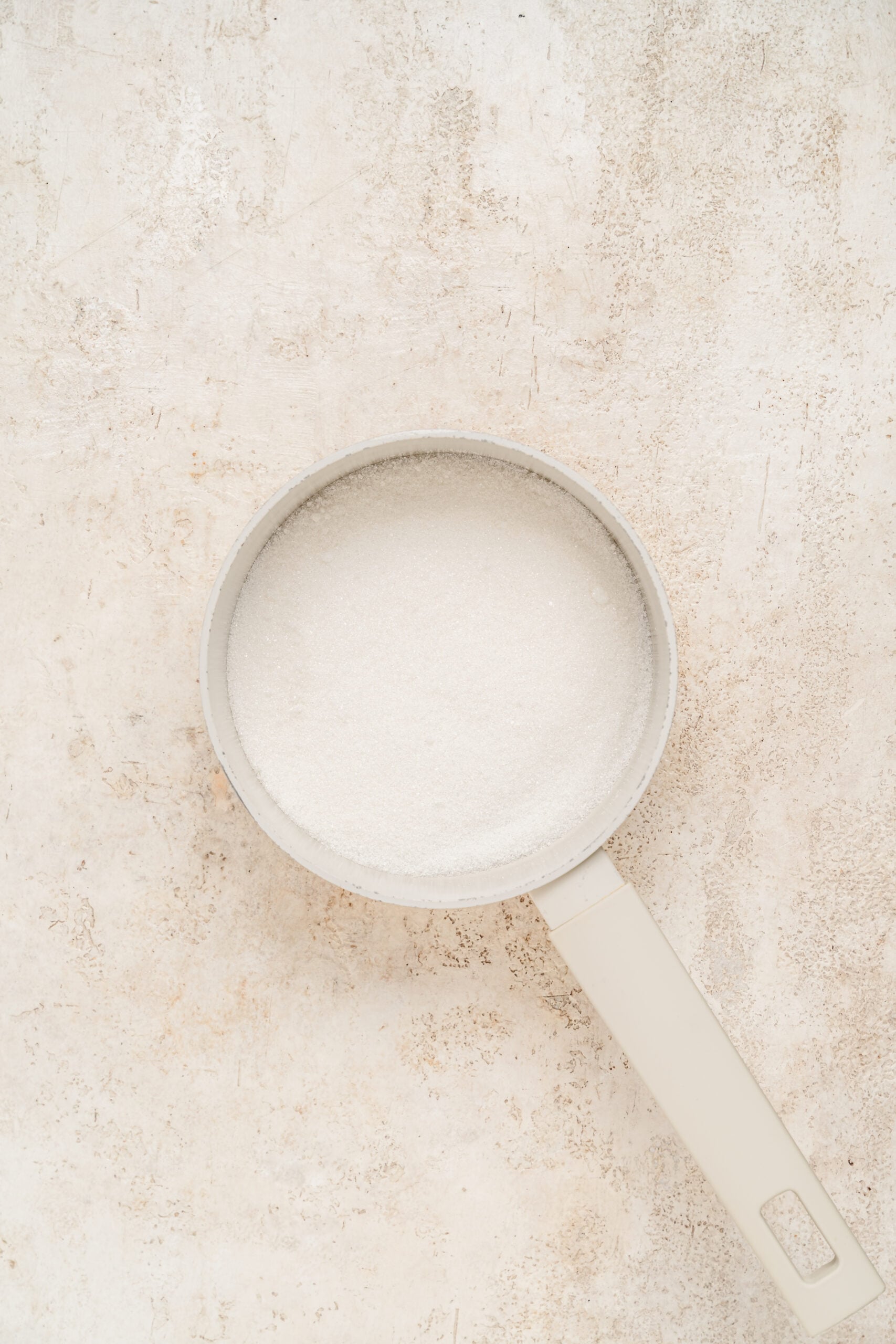 Granulated sugar in a small saucepan for dalgona candy - Catherine Zhang Granulated sugar in a small saucepan for dalgona candy