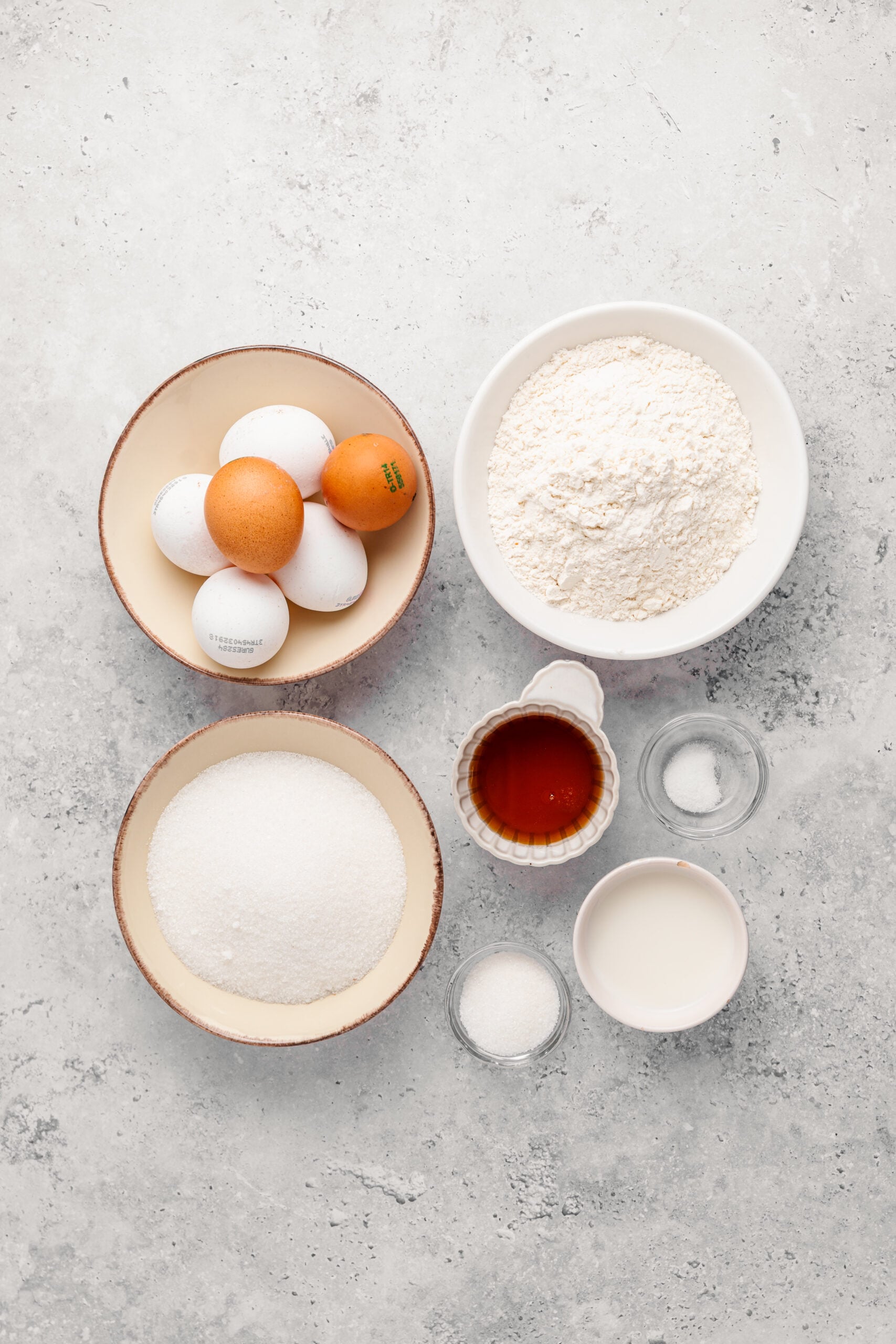 Japanese castella cake ingredients laid out: eggs, bread flour, caster sugar, honey, milk and salt - Catherine Zhang Japanese castella cake ingredients laid out: eggs, bread flour, caster sugar, honey, milk and salt