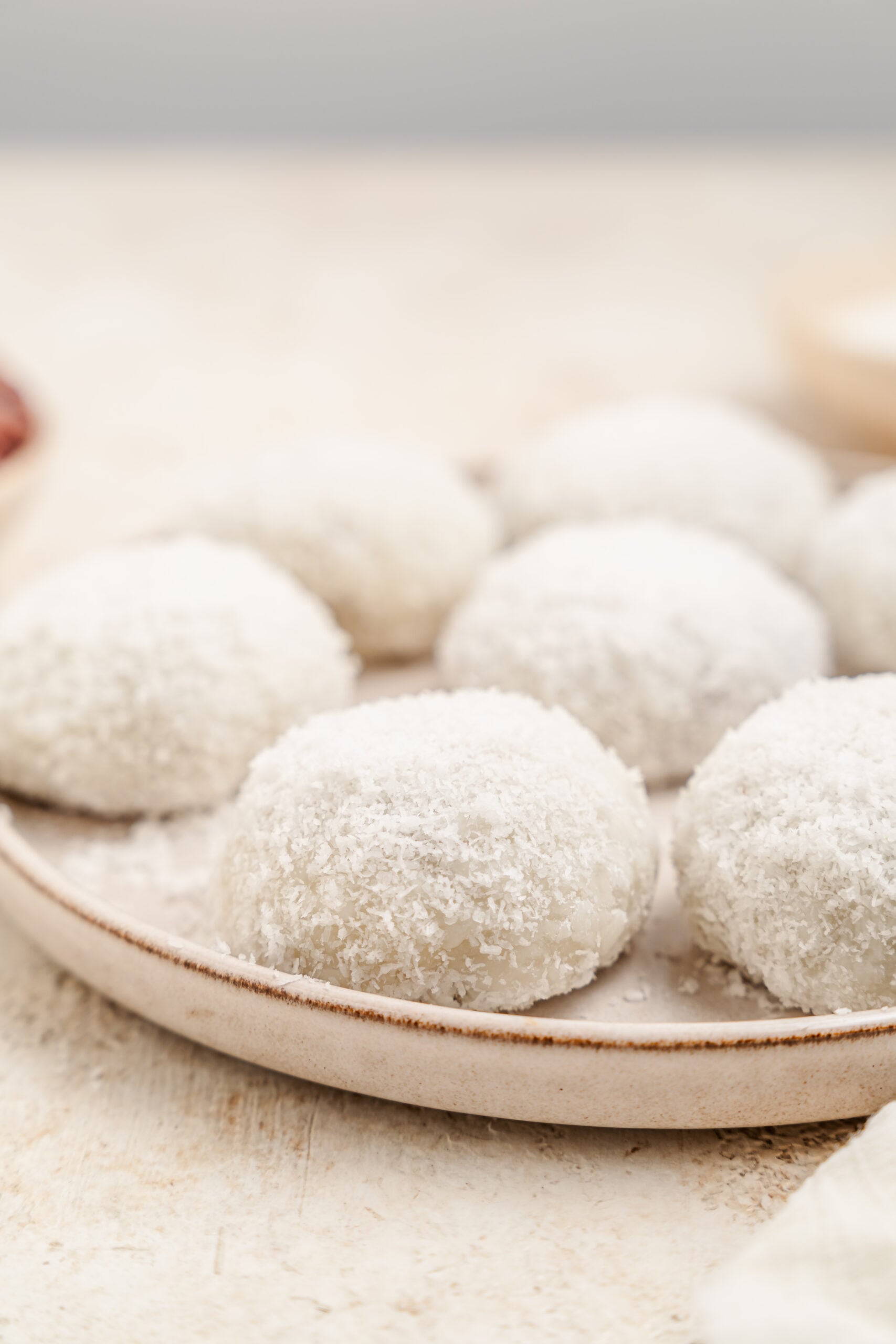 Close up of soft red bean mochi rolled in coconut - Catherine Zhang Close up of soft red bean mochi rolled in coconut