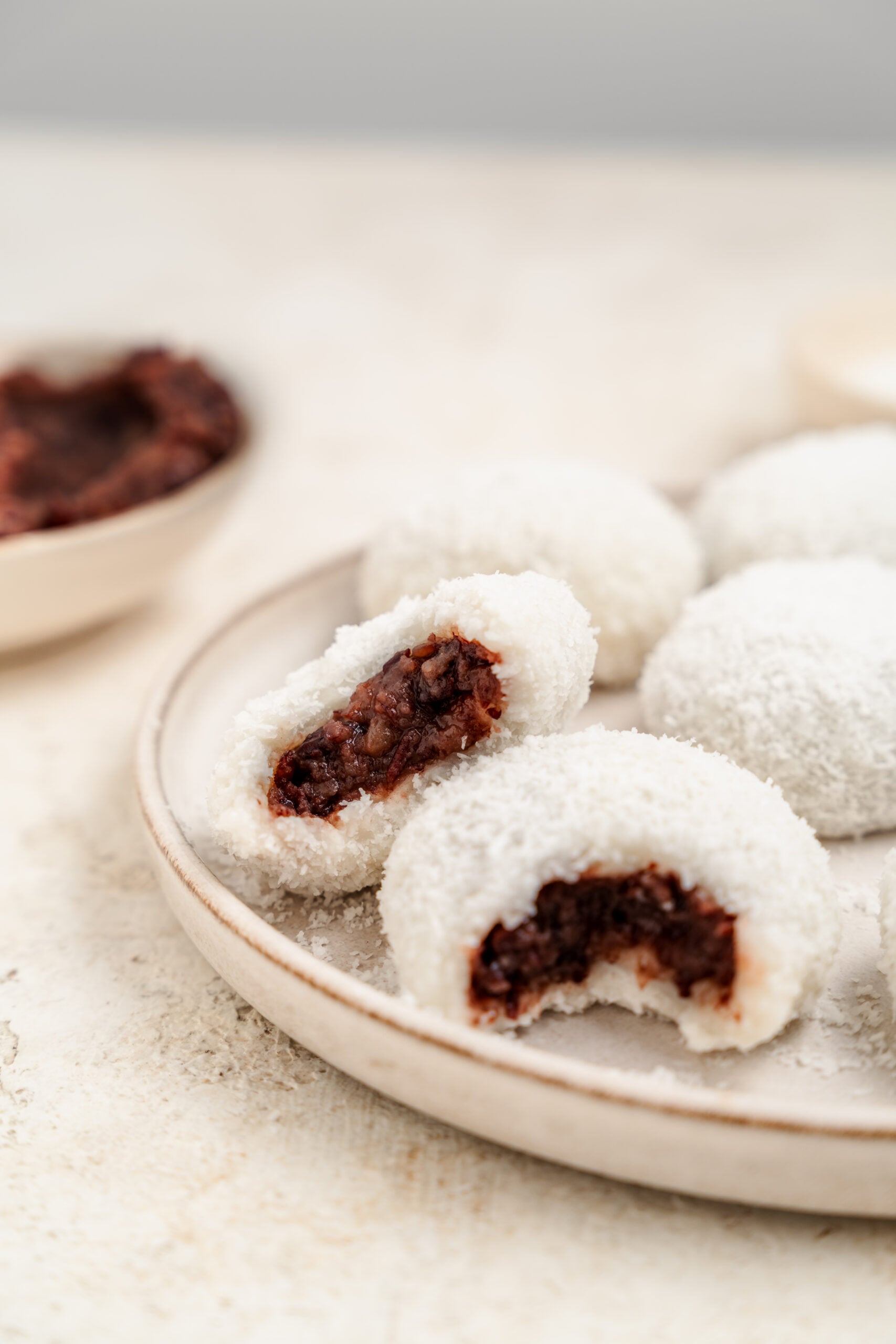 Clean cross section of red bean mochi showing dark adzuki paste against white dough - Catherine Zhang Clean cross section of red bean mochi showing dark adzuki paste against white dough