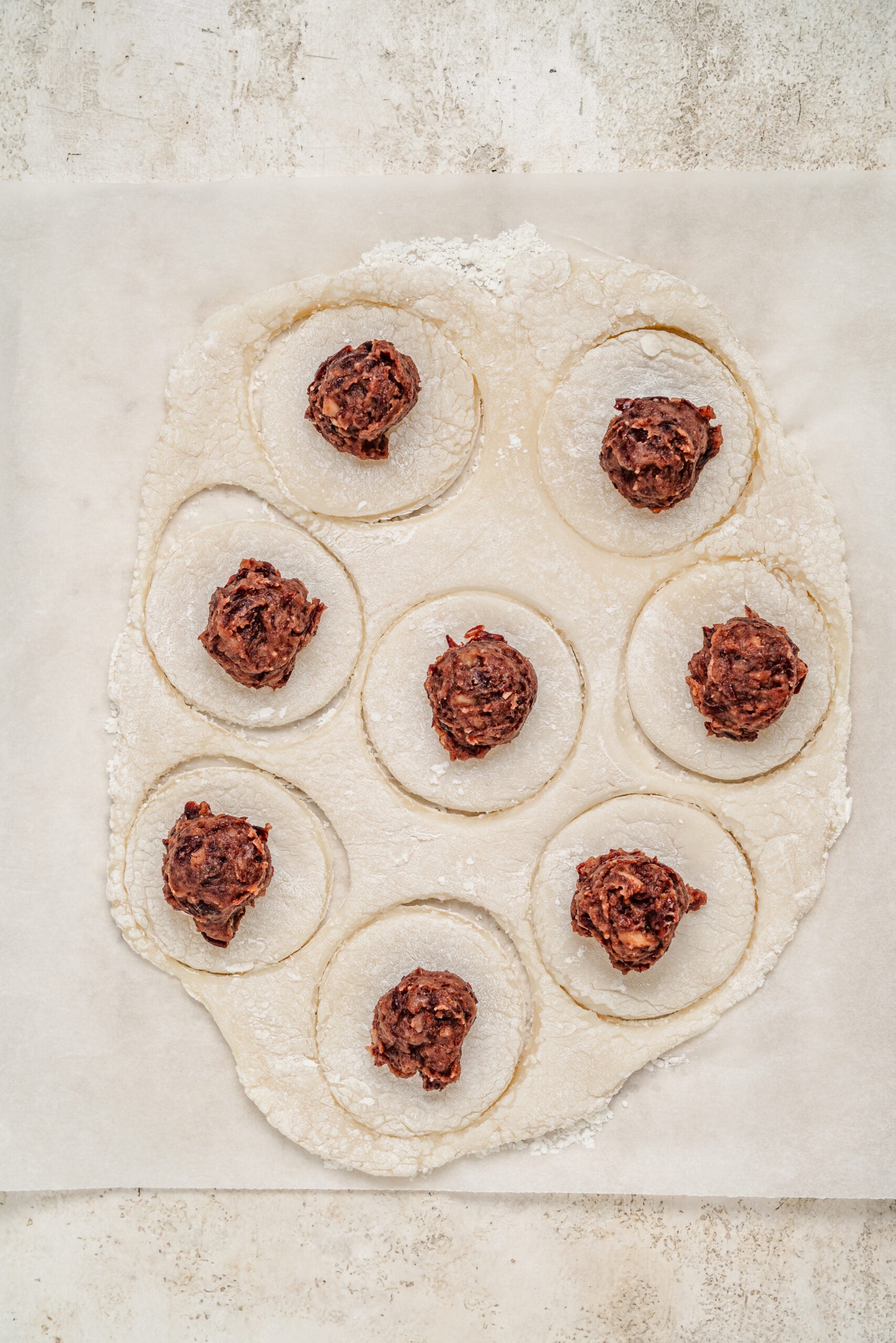 Chilled red bean paste balls placed on rounds of mochi dough - Catherine Zhang Chilled red bean paste balls placed on rounds of mochi dough