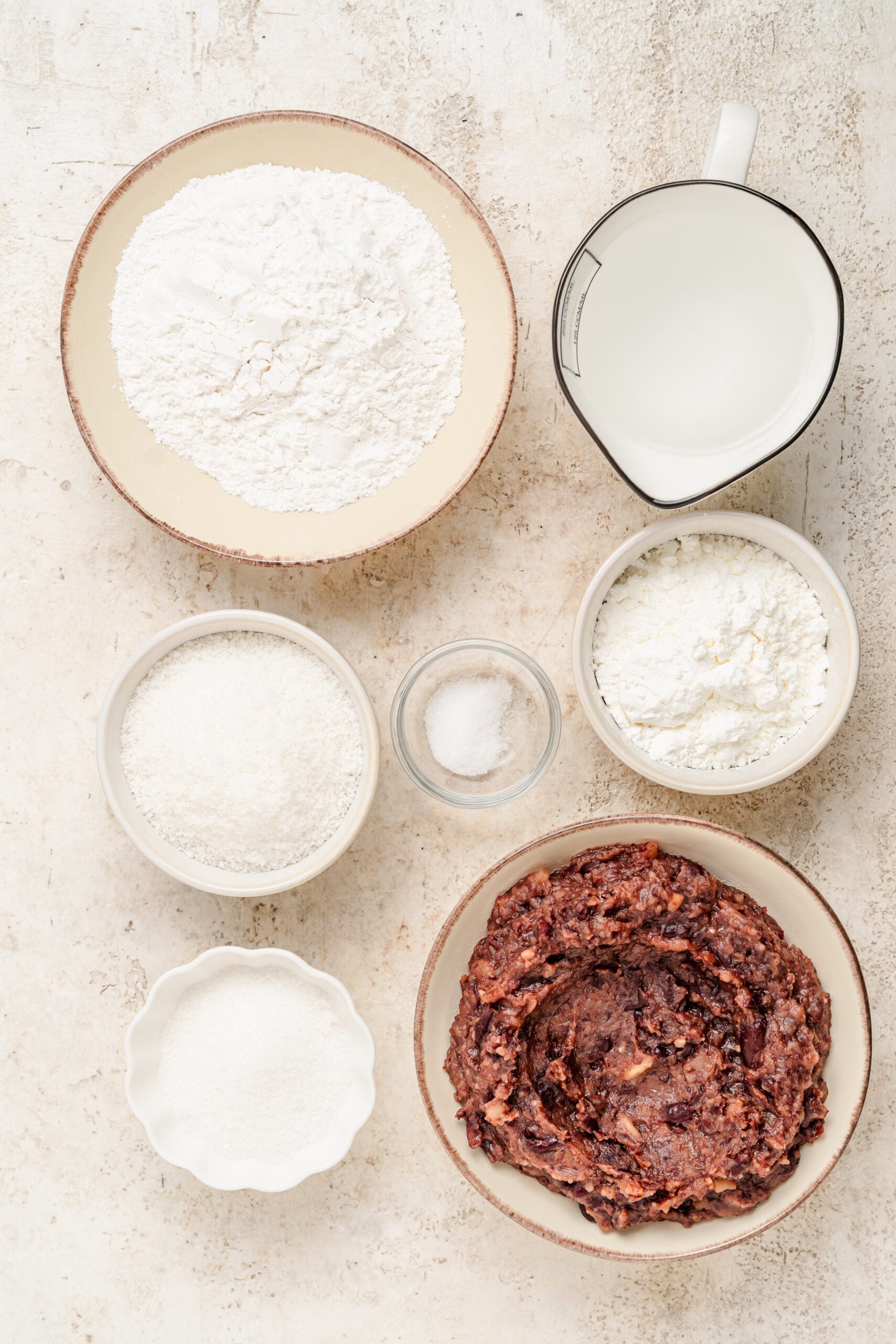 Red bean mochi ingredients laid out: glutinous rice flour, sugar, water and sweet red bean paste - Catherine Zhang Red bean mochi ingredients laid out: glutinous rice flour, sugar, water and sweet red bean paste