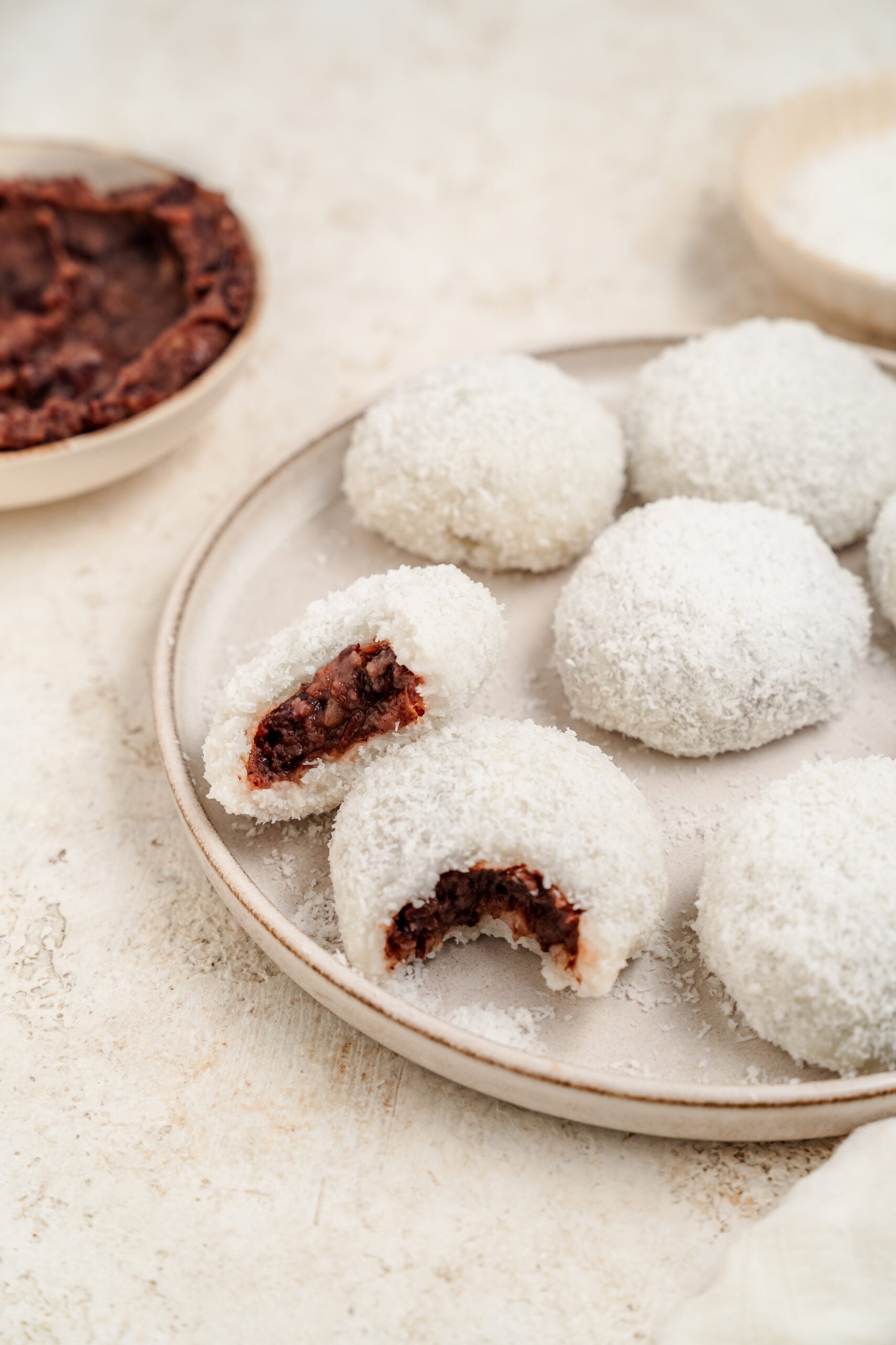Overhead of red bean mochi with a bowl of sweet red bean paste - Catherine Zhang Overhead of red bean mochi with a bowl of sweet red bean paste