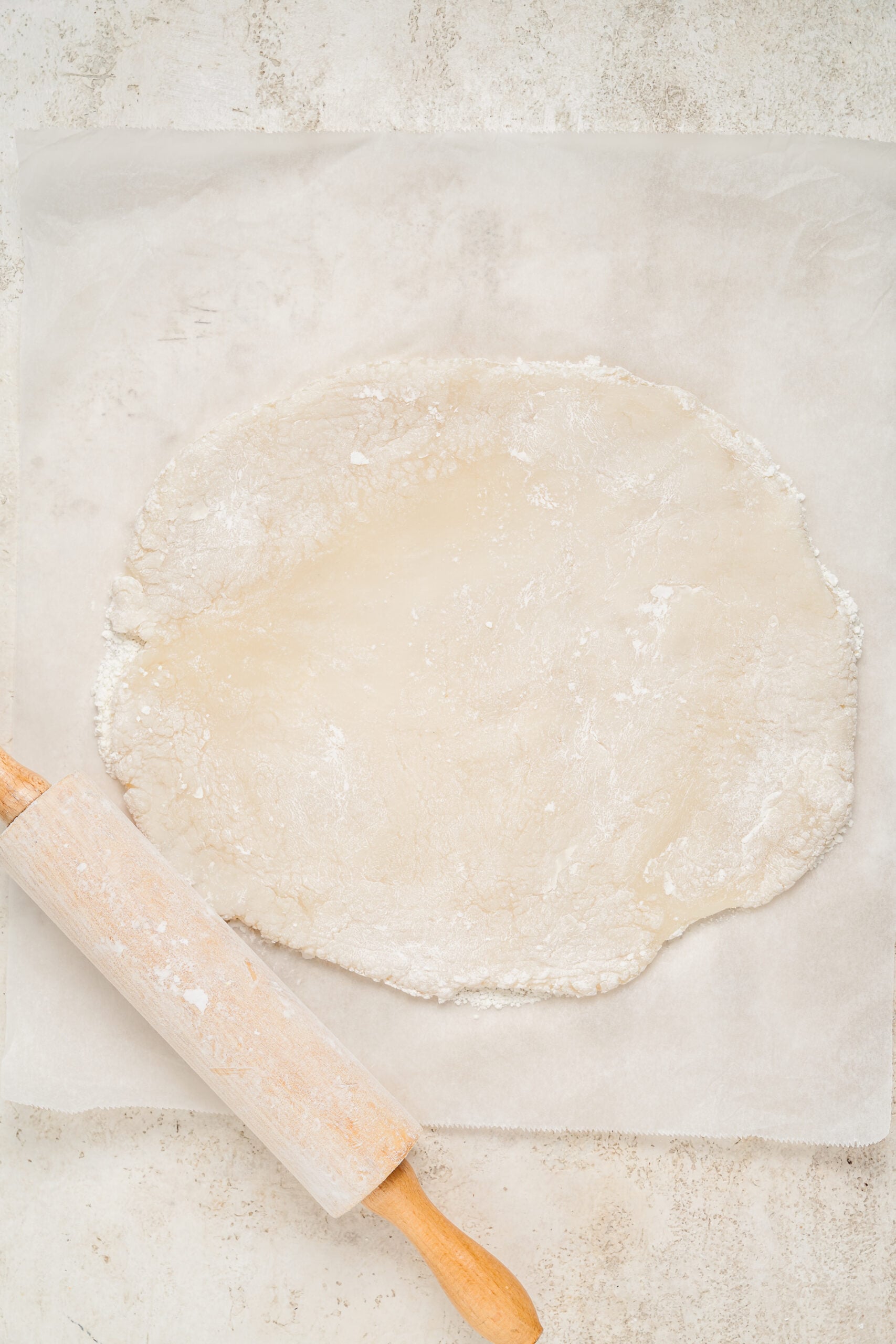 Mochi dough rolled flat on starch dusted parchment - Catherine Zhang Mochi dough rolled flat on starch dusted parchment