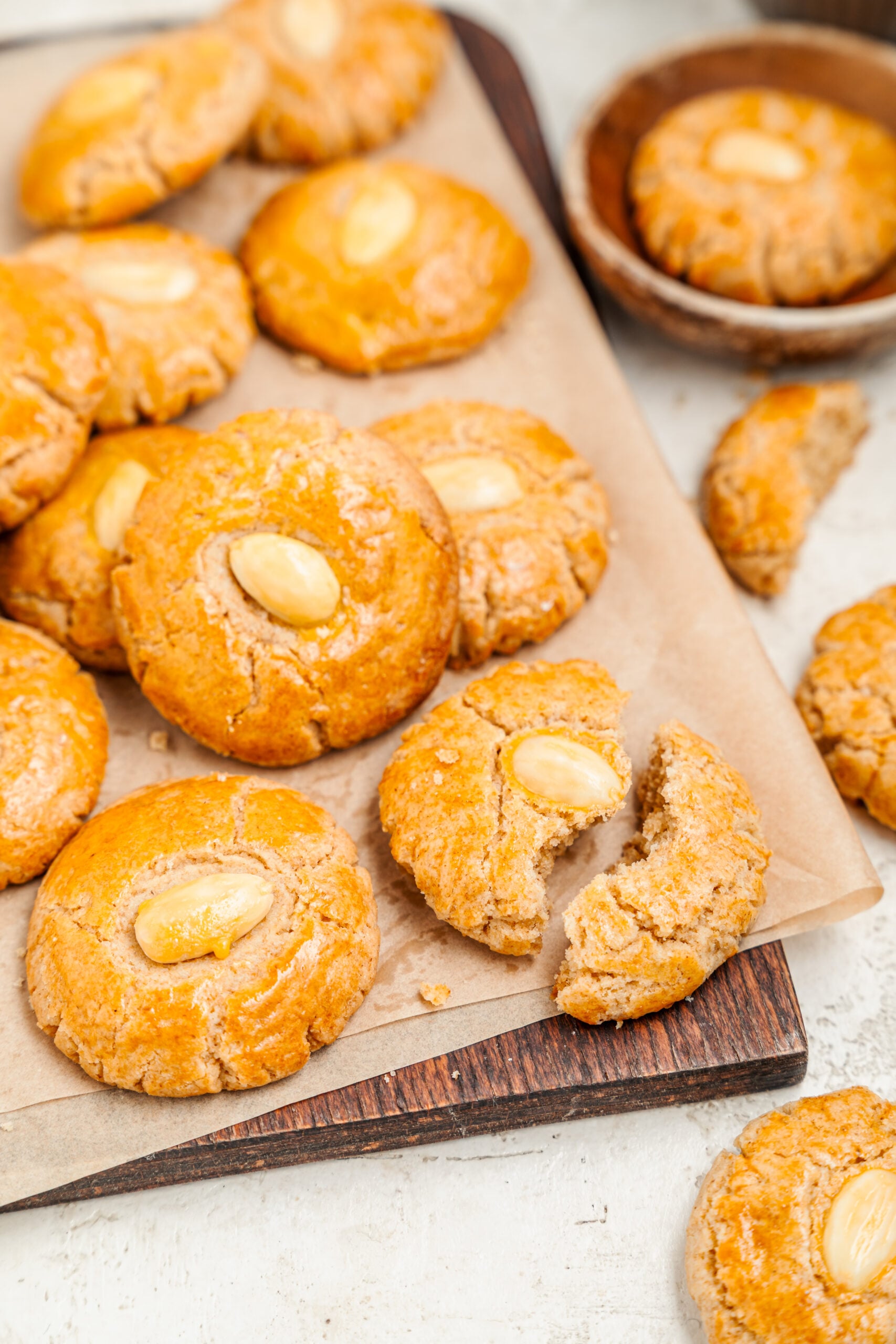 Chinese Almond Cookies - Catherine Zhang Chinese almond cookies on a board with one broken open