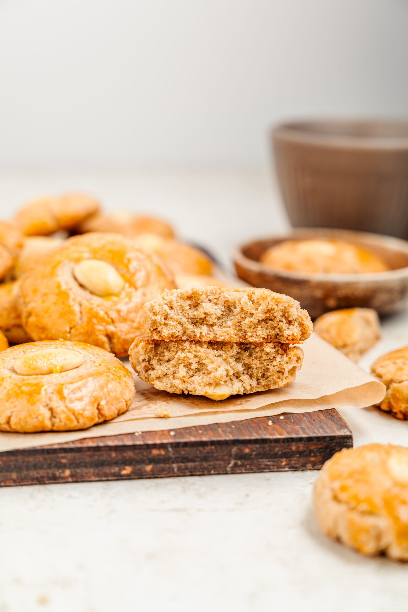 Chinese Almond Cookies - Catherine Zhang A Chinese almond cookie snapped in half showing the crisp, sandy interior