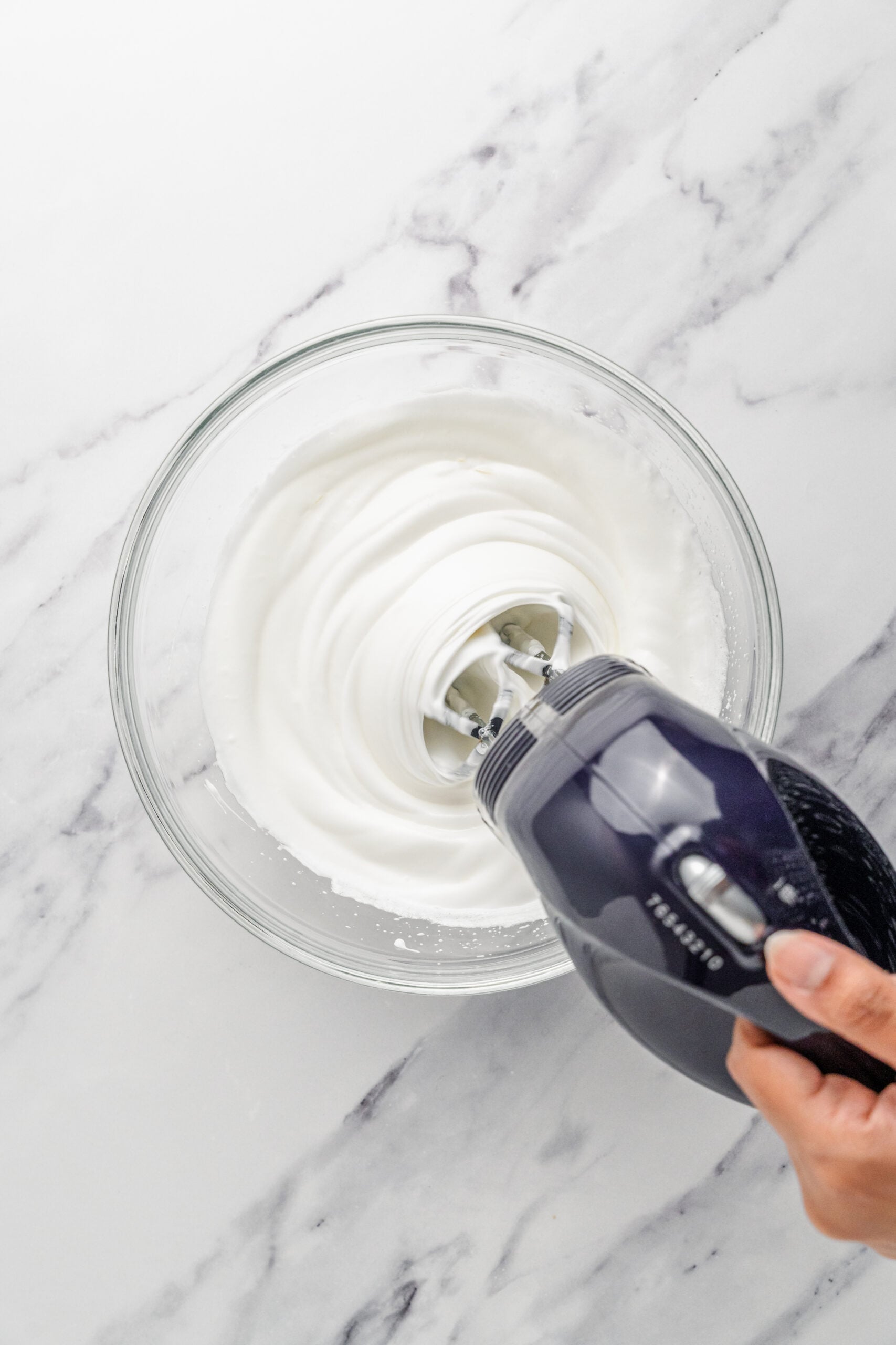 Egg whites at firm peaks - Catherine Zhang Egg whites whipped to firm glossy peaks in a glass bowl