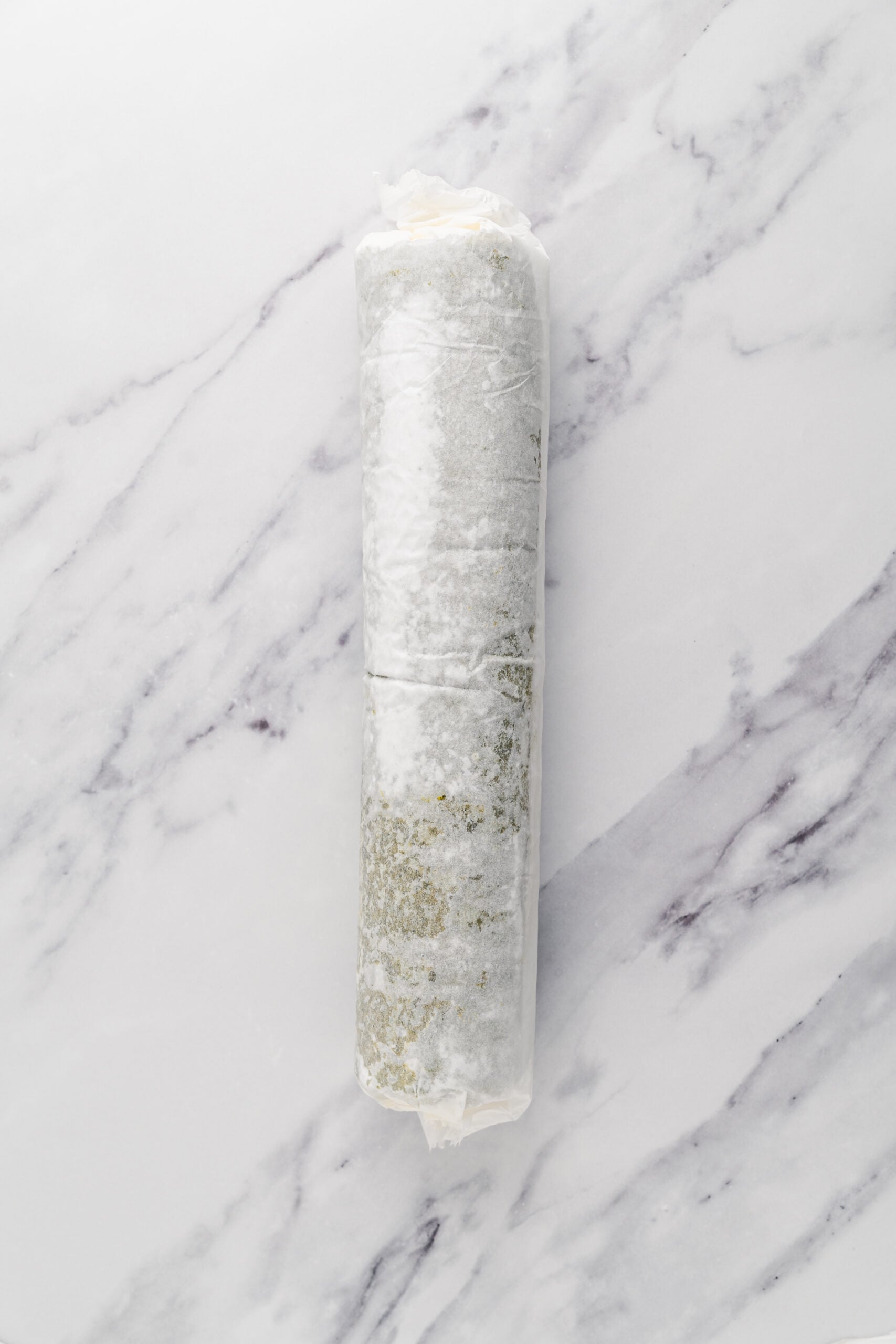 Wrapped and chilling - Catherine Zhang The filled matcha roll cake re rolled and wrapped in parchment to chill