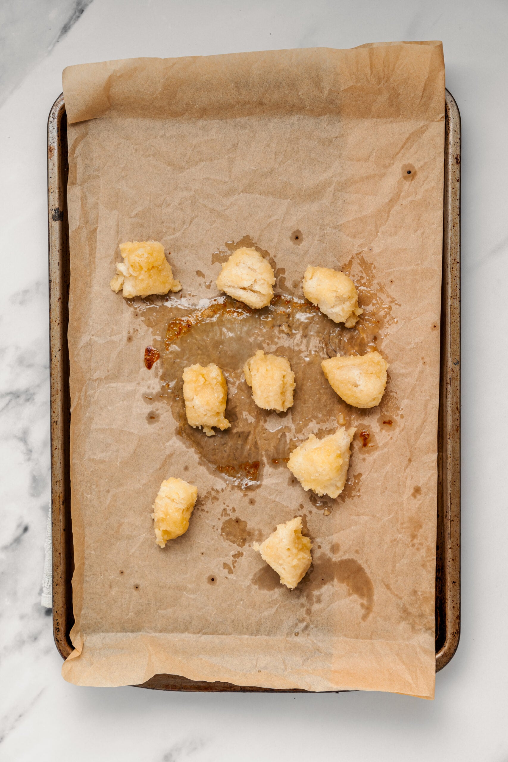 Shibuya Honey Toast - Catherine Zhang Honey butter coated bread cubes spread on a baking tray