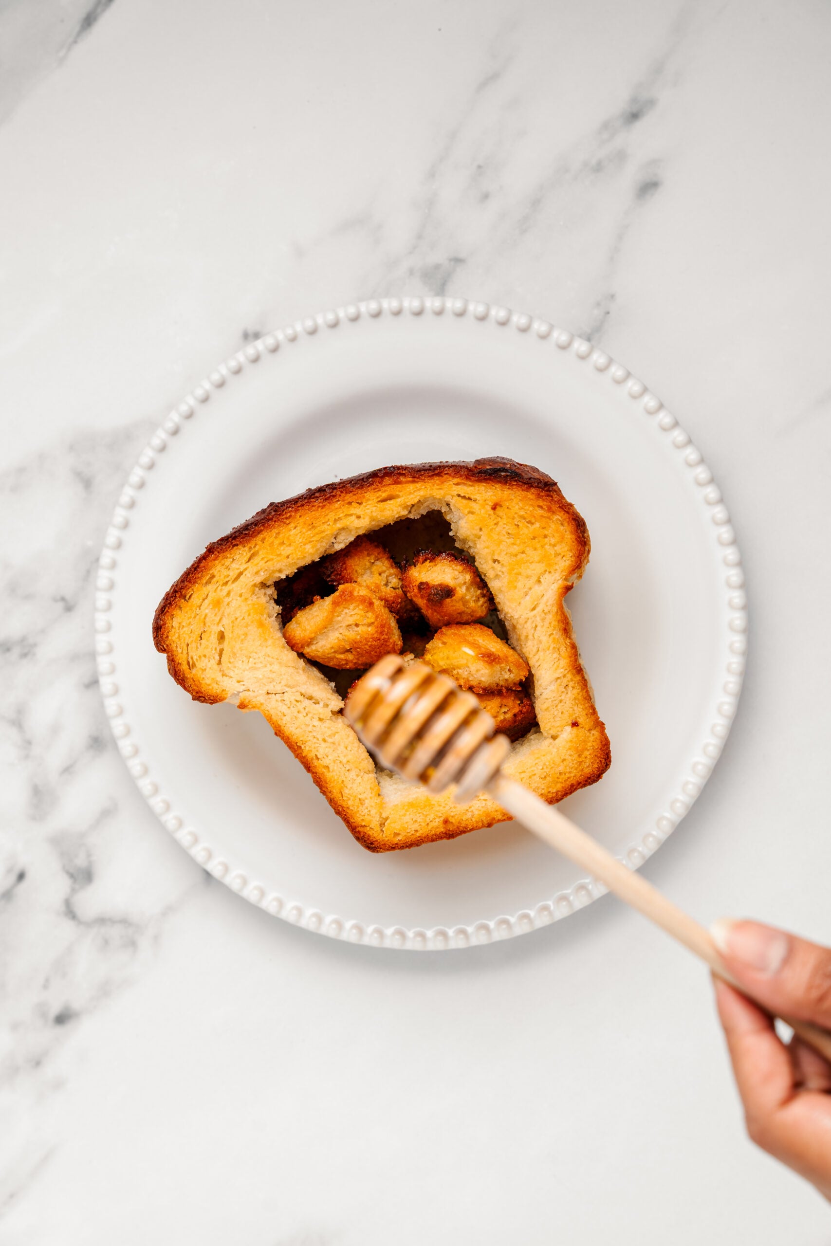 Shibuya Honey Toast - Catherine Zhang Drizzling honey over the toasted cubes in the bread box