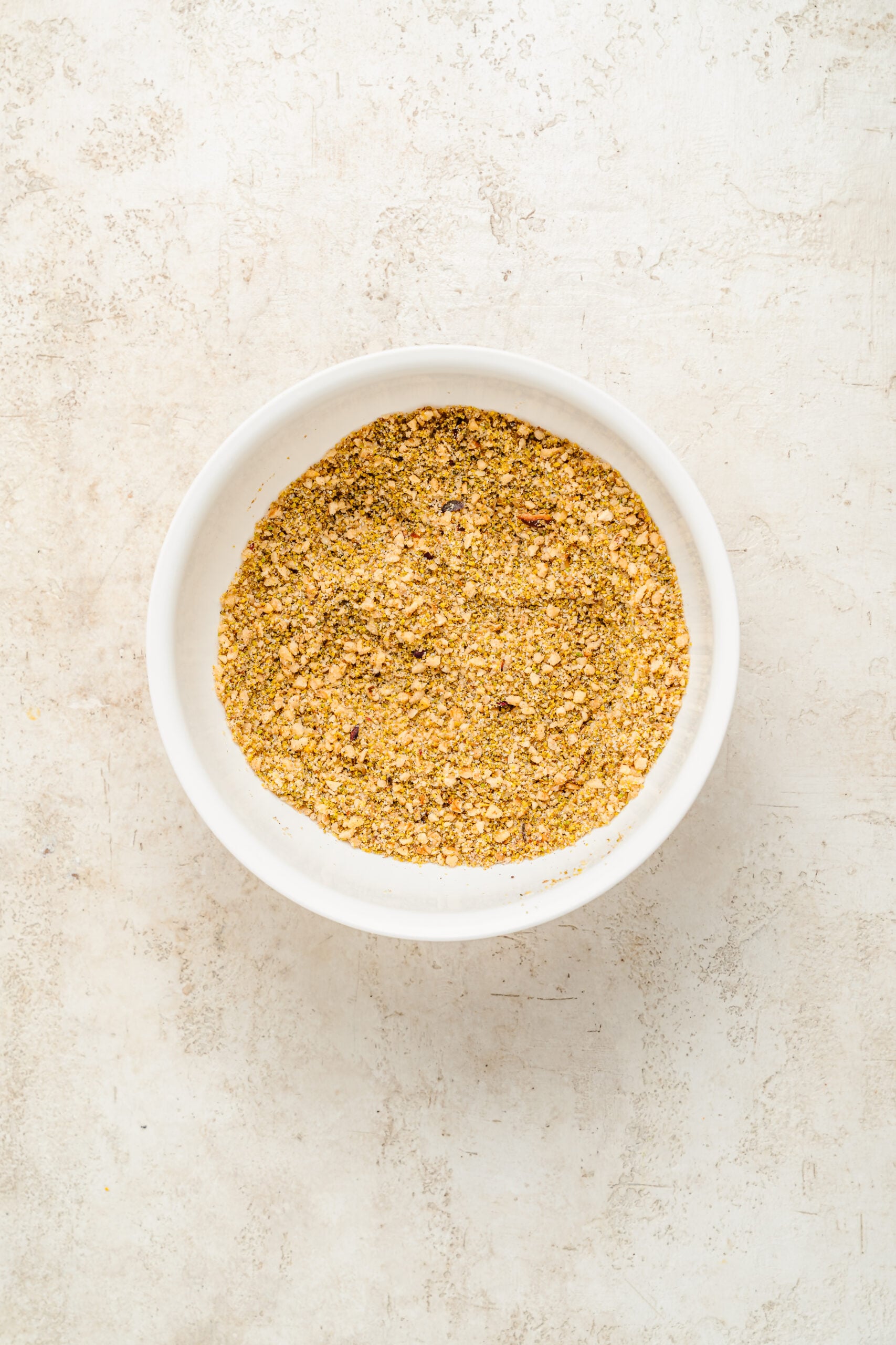 Pistachio and walnut baklava filling - Catherine Zhang Pistachio and walnut baklava filling mixed with sugar, cinnamon and salt in a white bowl