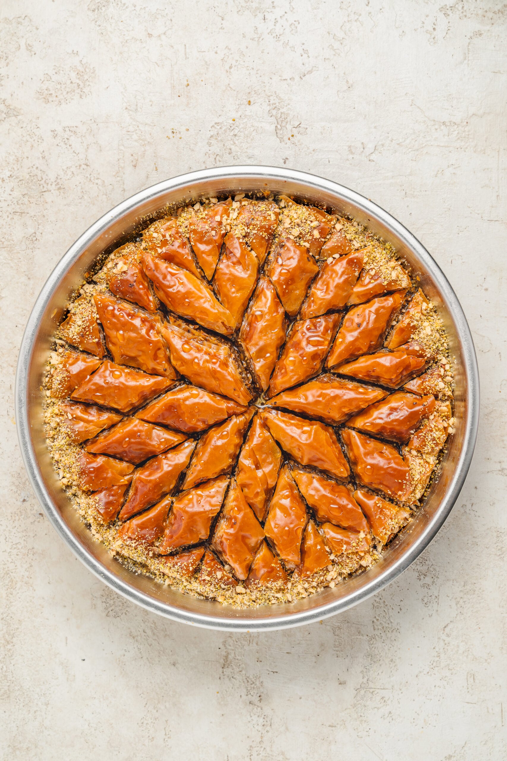Baklava finished with chopped pistachios - Catherine Zhang Finely chopped pistachios scattered over the syruped baklava while the surface is still wet