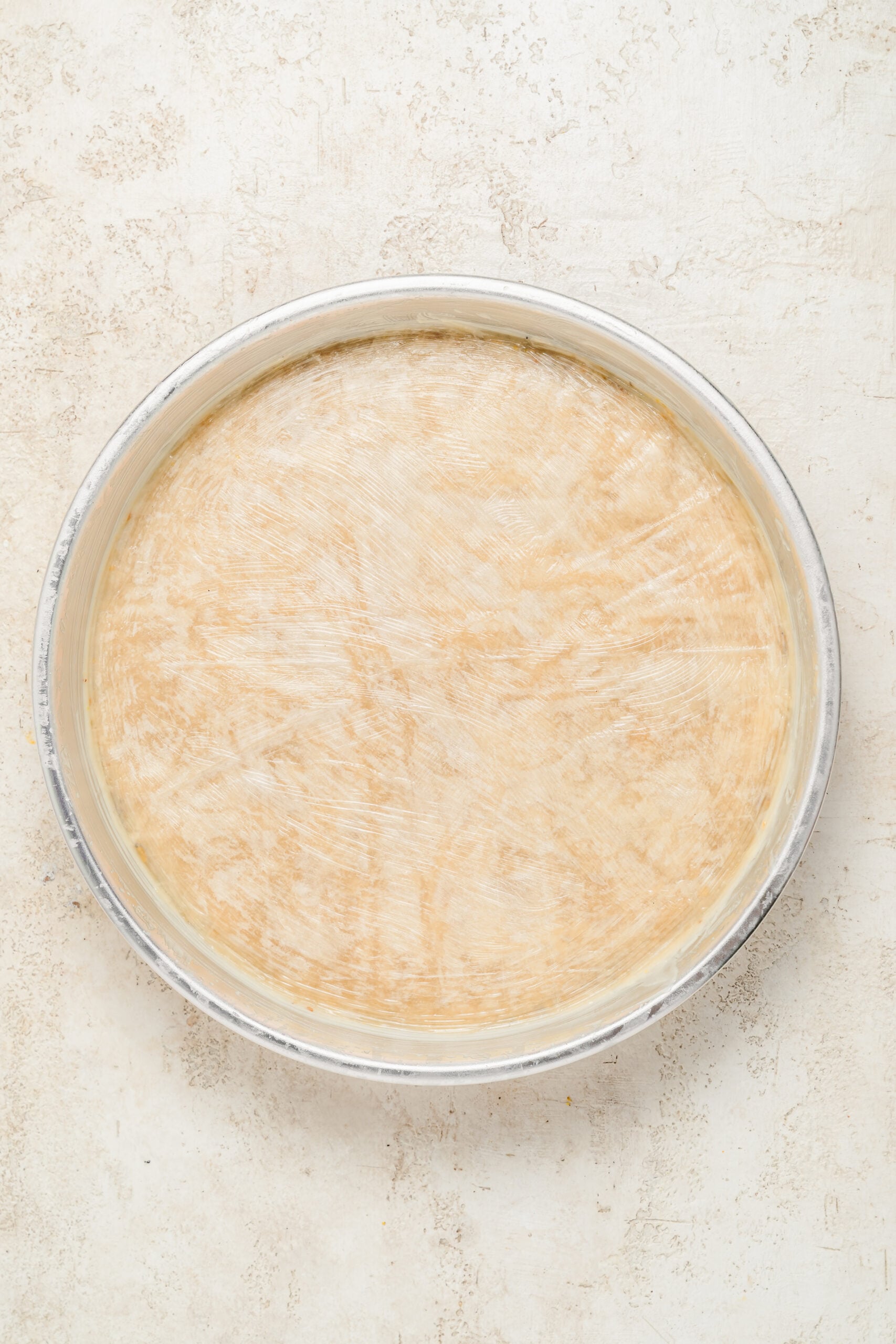 Buttered phyllo crown on the baklava - Catherine Zhang The final buttered phyllo sheets forming a smooth pale crown on top of the baklava