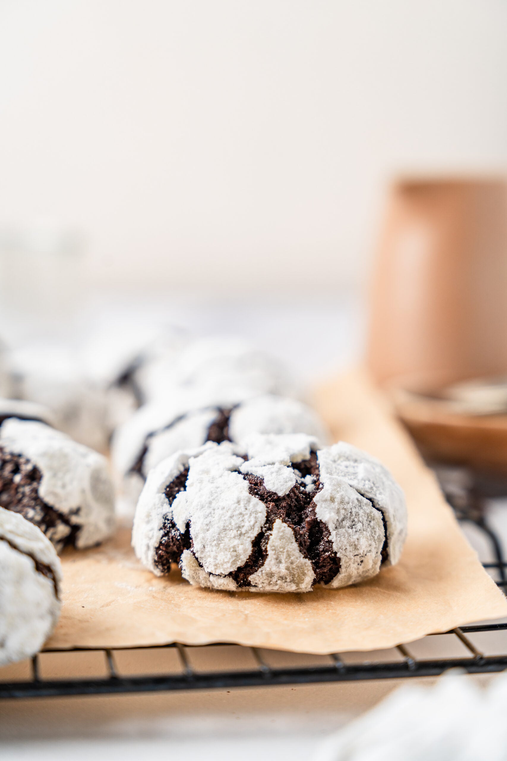chocolate-crinkle-cookies-close-up - Catherine Zhang Close up of a chocolate crinkle cookie showing the wide dark cracks in the icing sugar coating