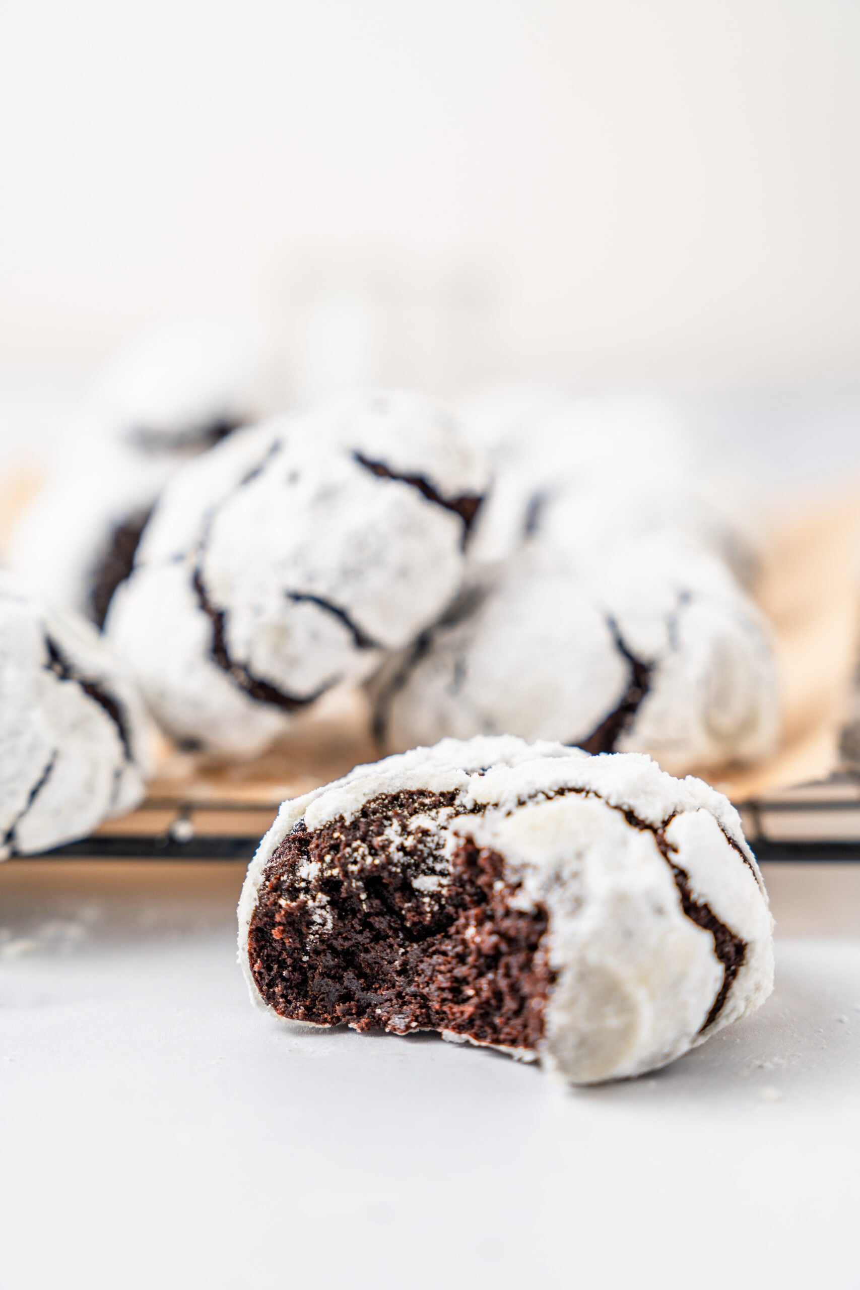 chocolate-crinkle-cookies-fudgy-centre - Catherine Zhang A chocolate crinkle cookie broken open to show the dark fudgy centre
