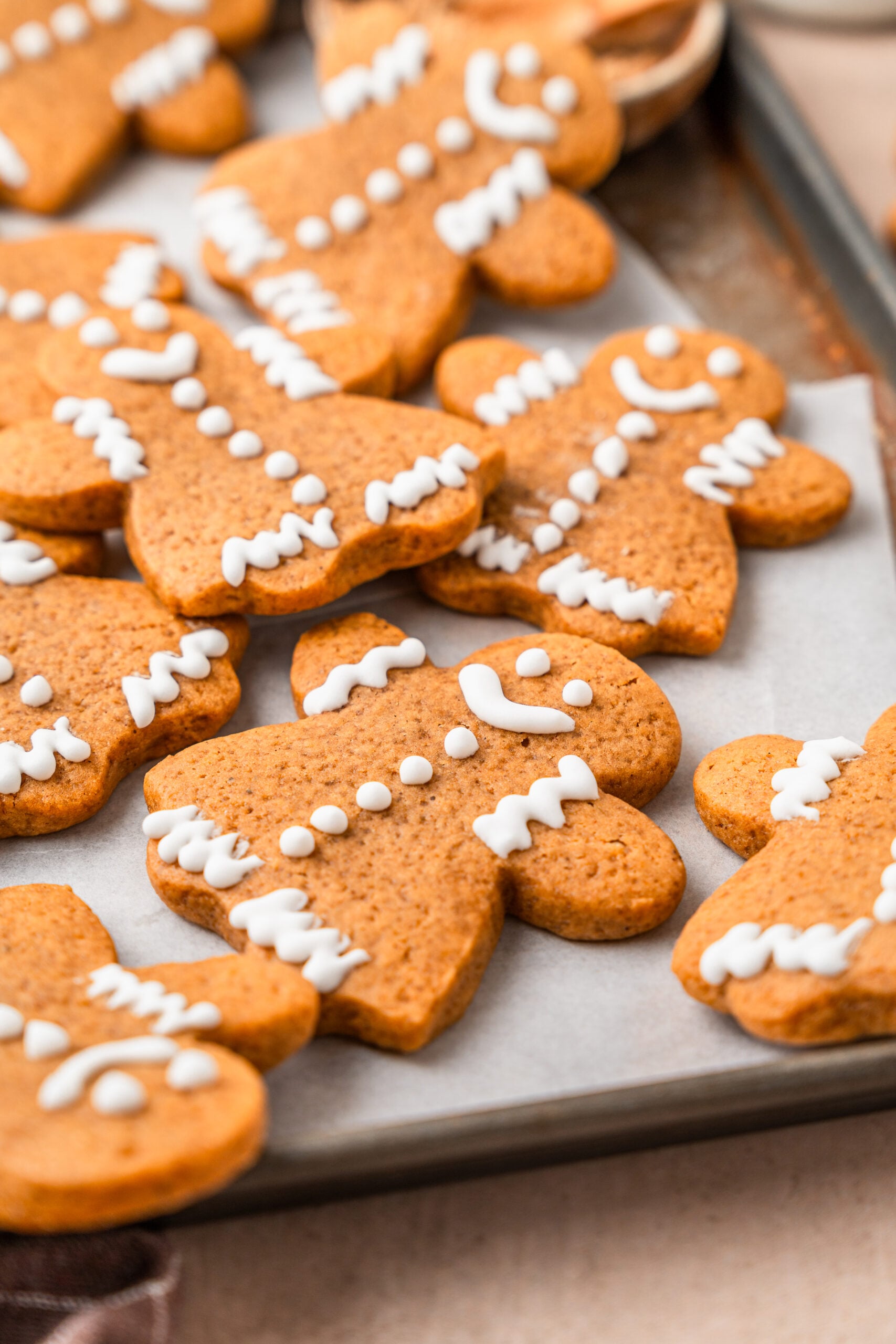 gingerbread-cookies-piped-icing - Catherine Zhang Gingerbread cookies piped with simple white royal icing faces and buttons