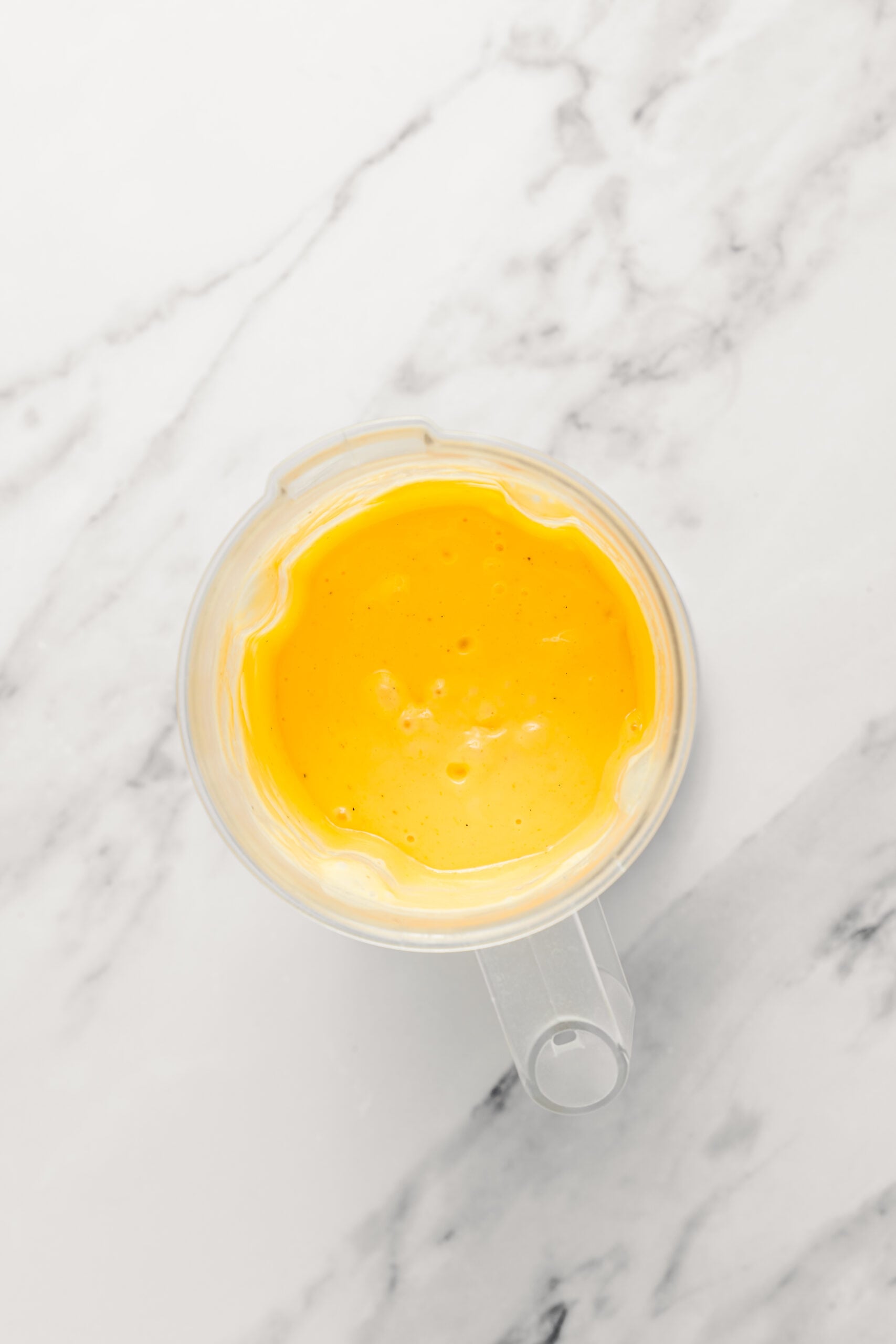 Mango lassi pulsed until just combined - Catherine Zhang Mango lassi pulsed to an even pale orange, thick and smooth in the blender jug