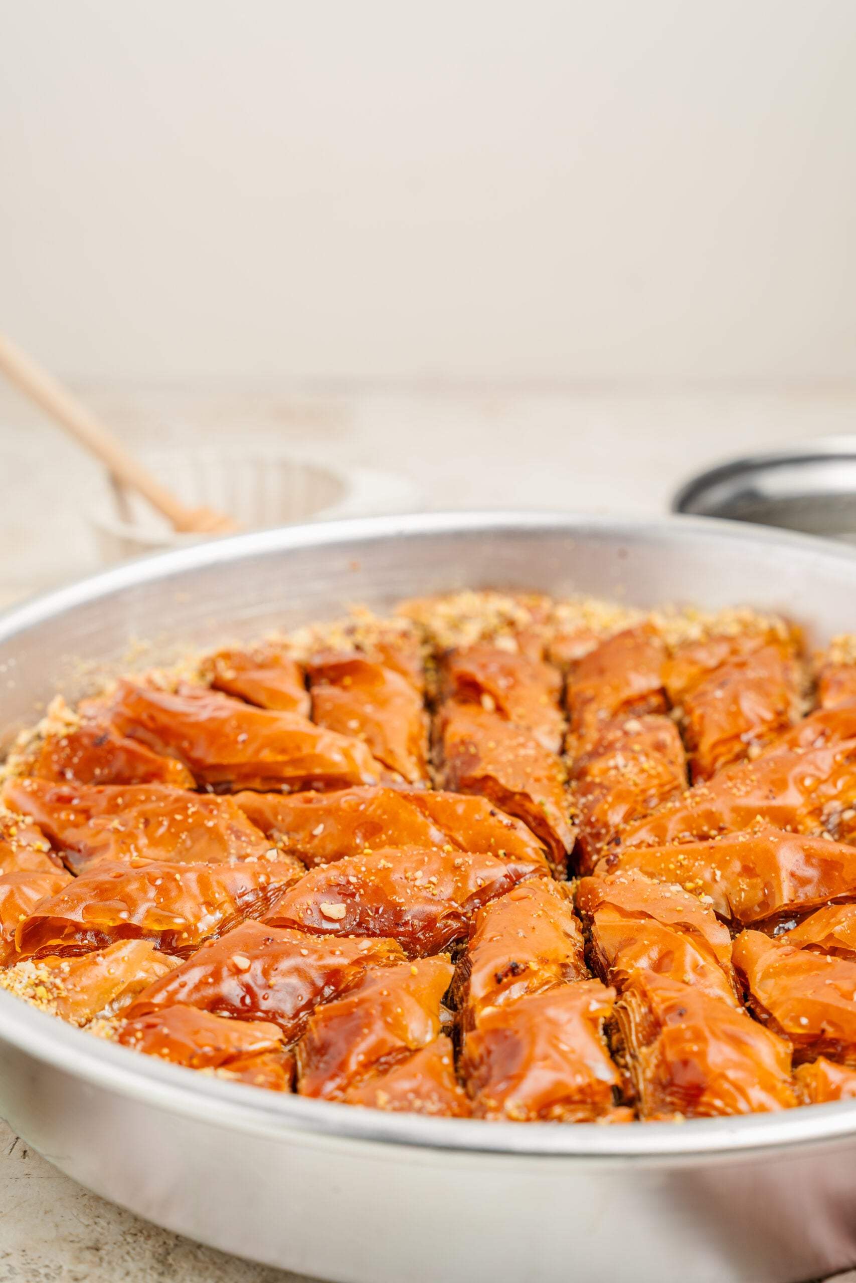 Pistachio baklava angled view - Catherine Zhang Pistachio baklava photographed at an angle, showing the crisp golden tops of each diamond