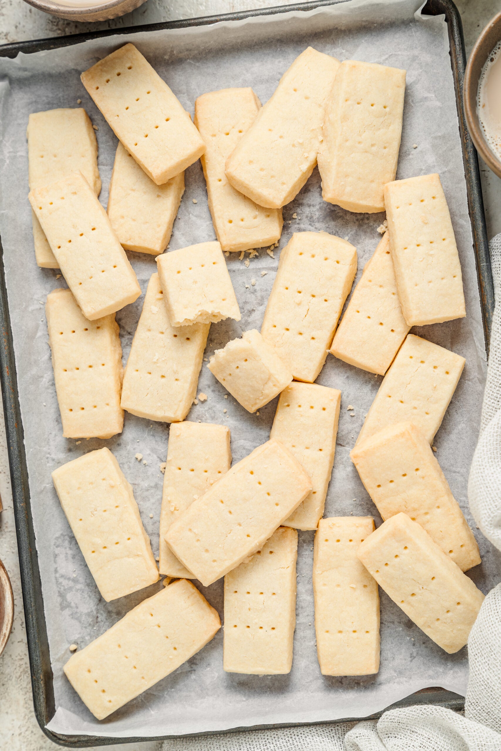 Classic shortbread cookies cooling in a loose pile on a tray - Catherine Zhang Classic shortbread cookies cooling in a loose pile on a tray