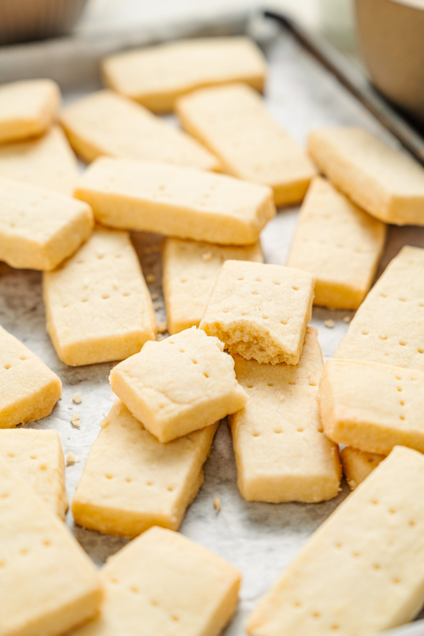 A shortbread cookie broken open to show its short sandy texture - Catherine Zhang A shortbread cookie broken open to show its short sandy texture